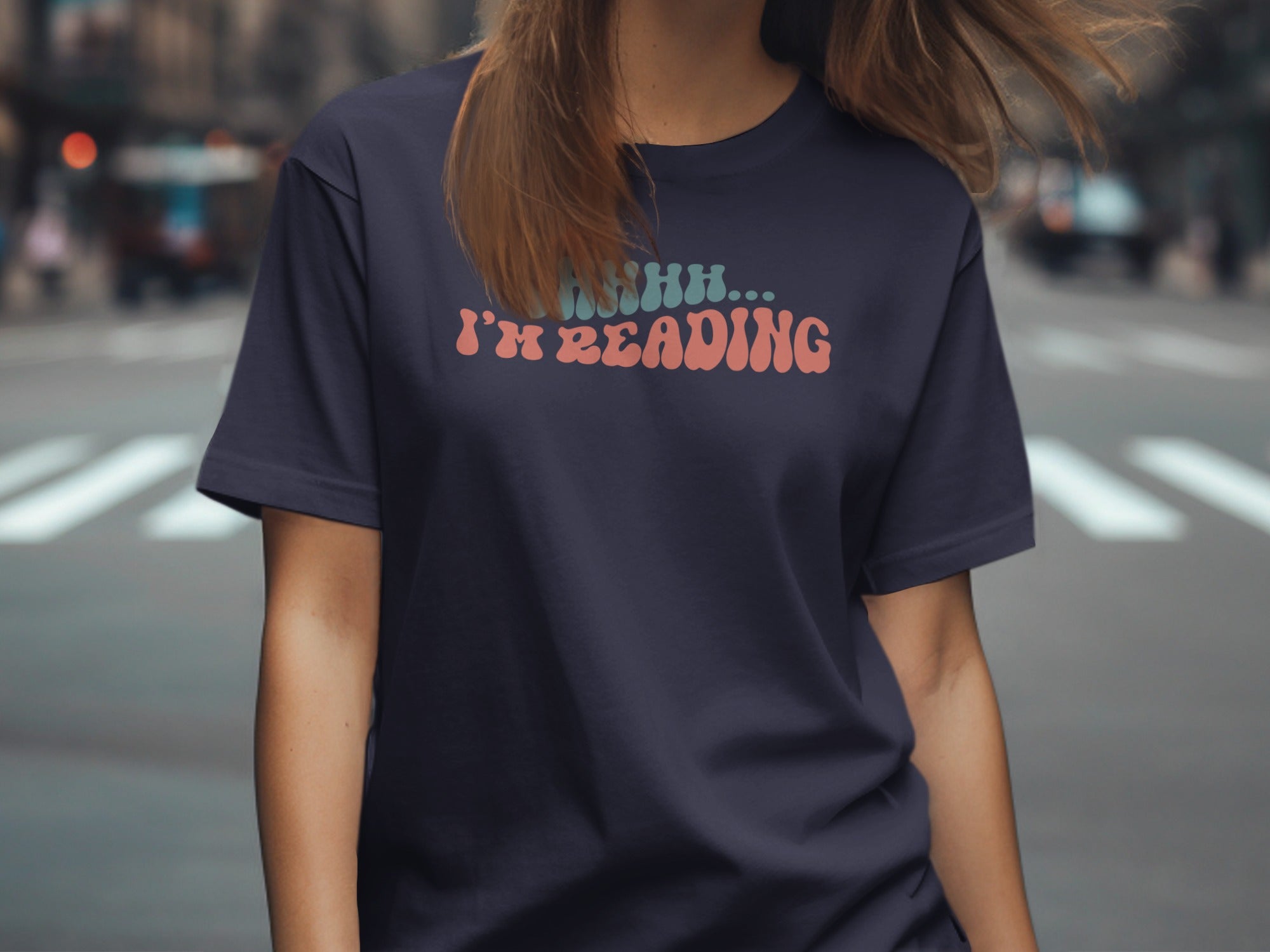 Dark navy t-shirt with "SHHH... I'M READING" graphic in retro font.