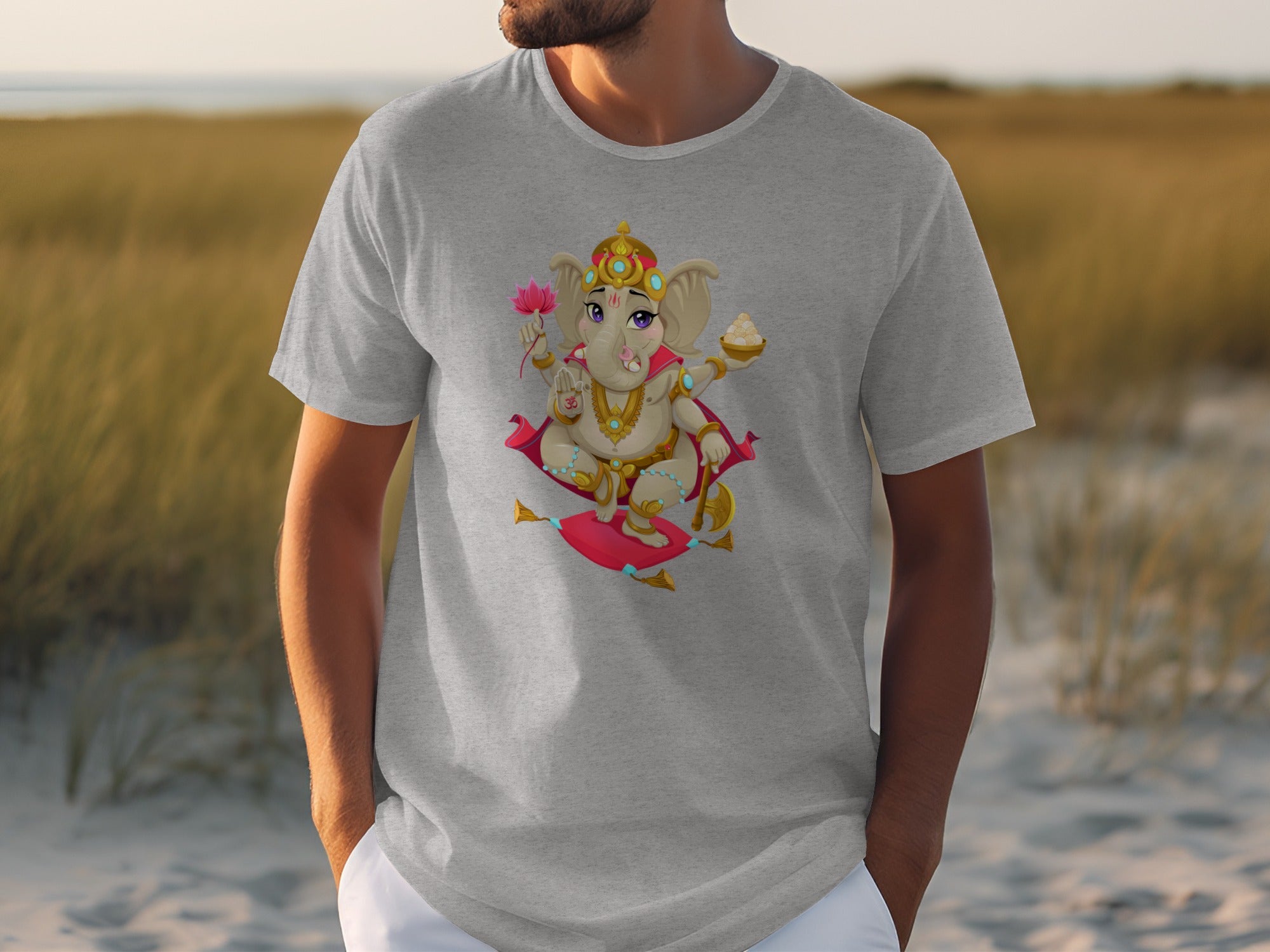 Grey t-shirt with a cartoon Ganesha holding a lotus and a bowl of sweets.