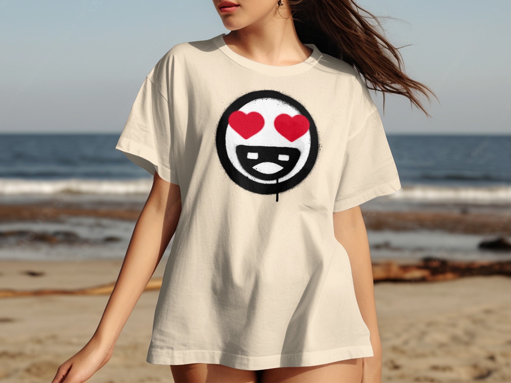 Cream t-shirt with a black circle graphic featuring a smiley face with red heart eyes.