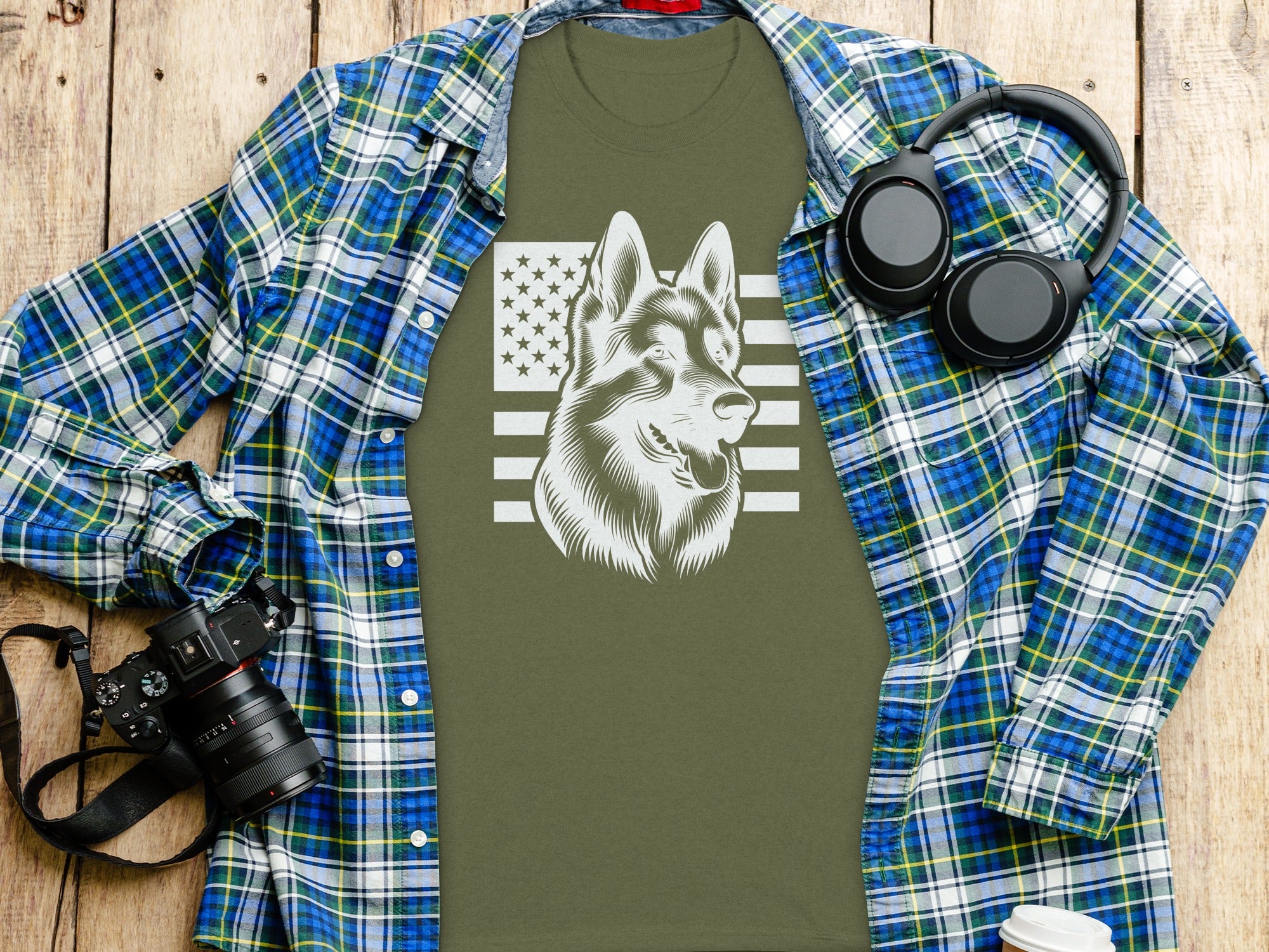 Olive green t-shirt with German Shepherd and American flag graphic, unbuttoned plaid shirt.