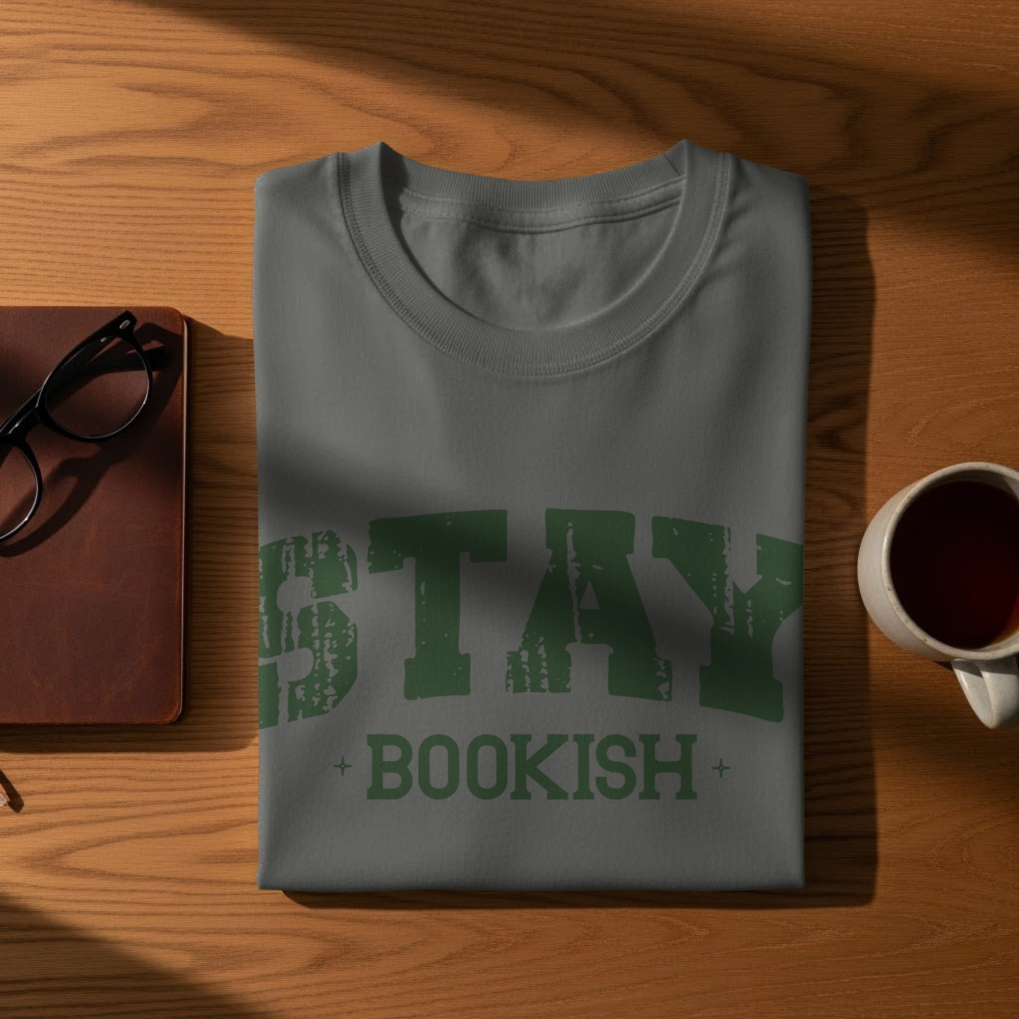 Grey t-shirt with distressed green text "STAY + BOOKISH".