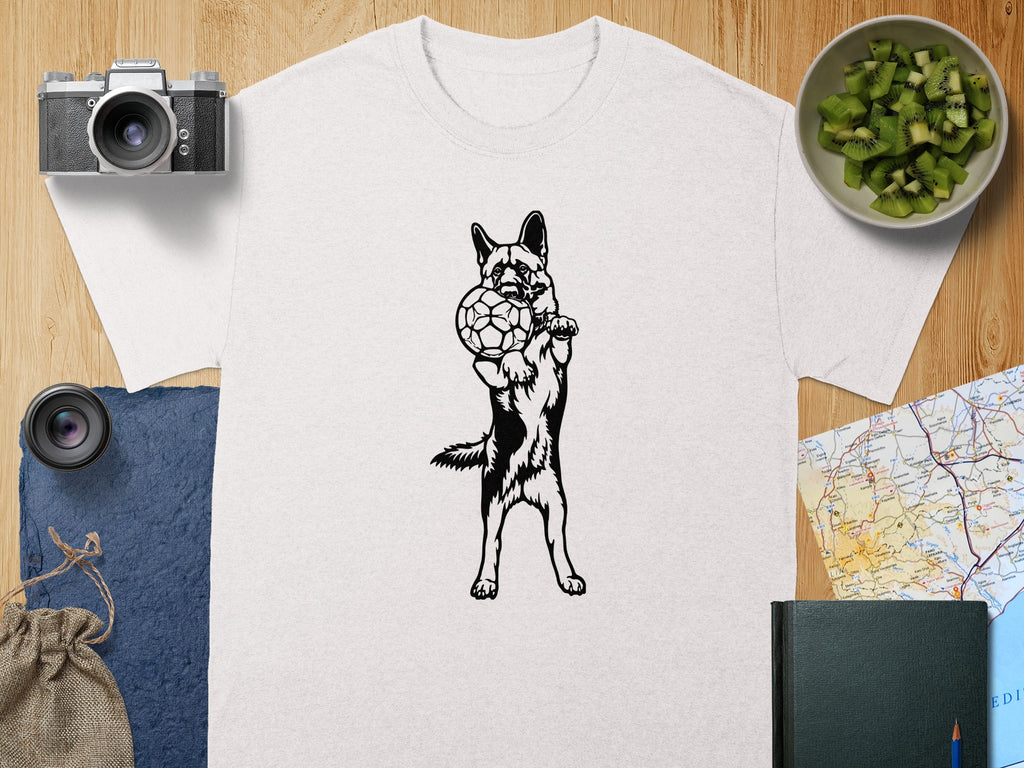 White t-shirt with black silhouette of German Shepherd holding a soccer ball.