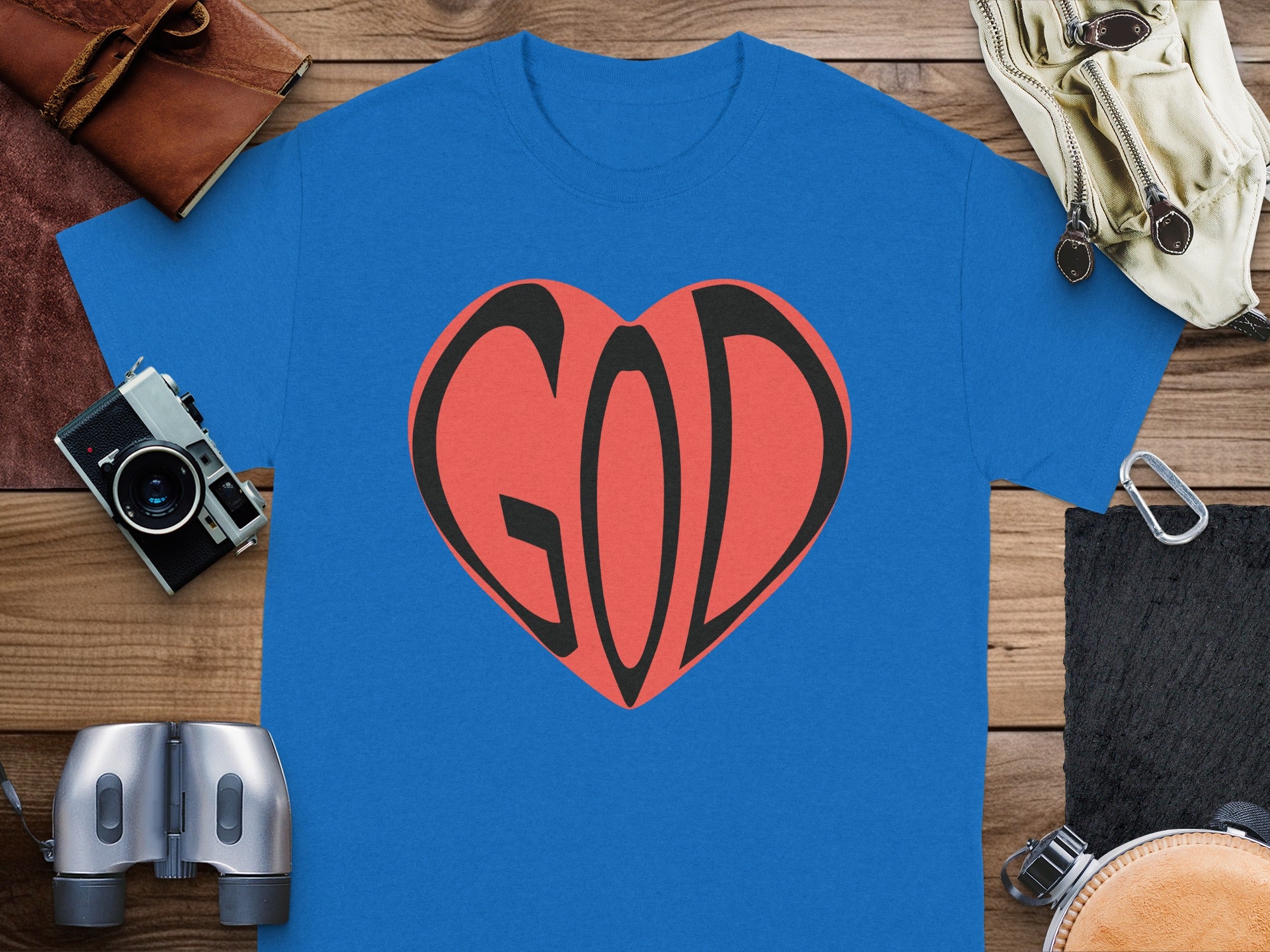 Blue t-shirt with a red heart graphic containing the word "GOD".