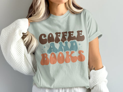 Light blue t-shirt with "COFFEE AND BOOKS" in groovy font, light blue and coral.