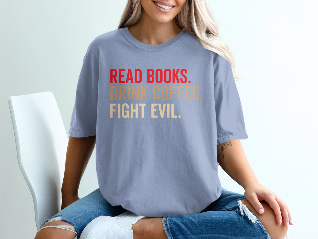 Light blue t-shirt with text: READ BOOKS. DRINK COFFEE. FIGHT EVIL.