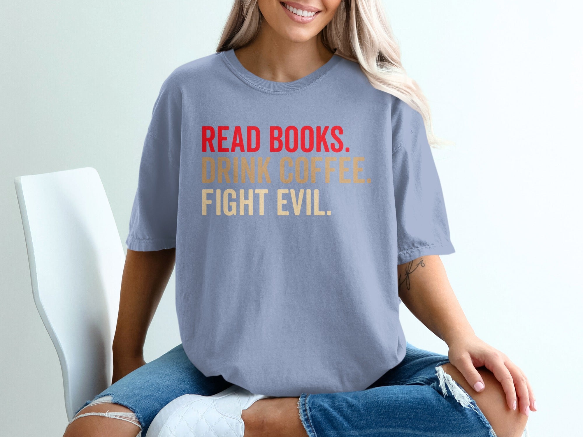 Light blue t-shirt with text: READ BOOKS. DRINK COFFEE. FIGHT EVIL.
