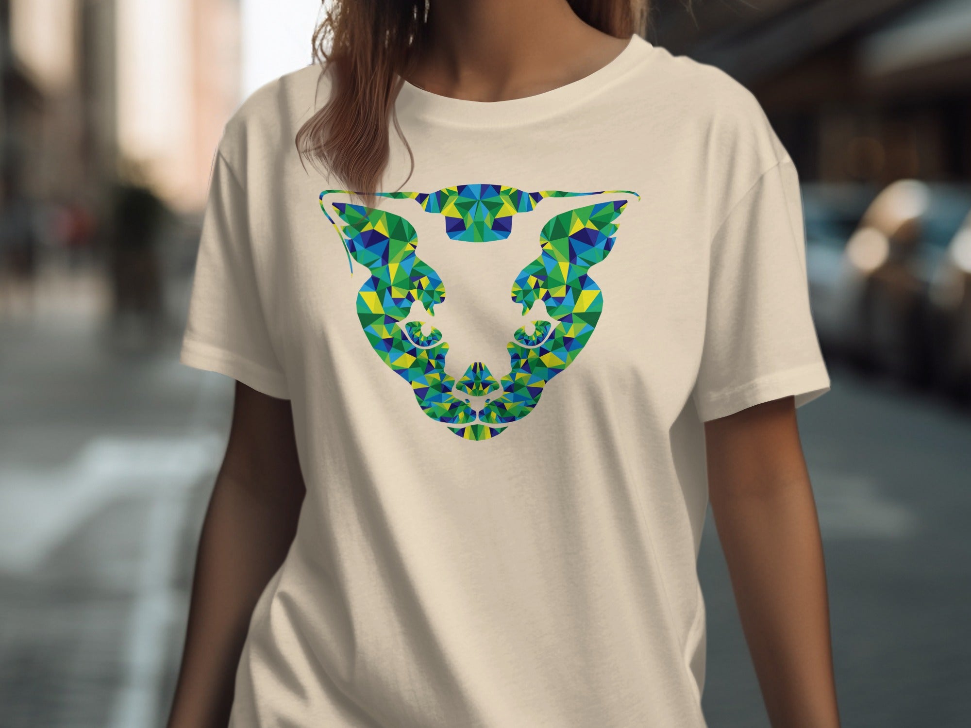 Cream t-shirt with abstract geometric jaguar head graphic in blue and green.