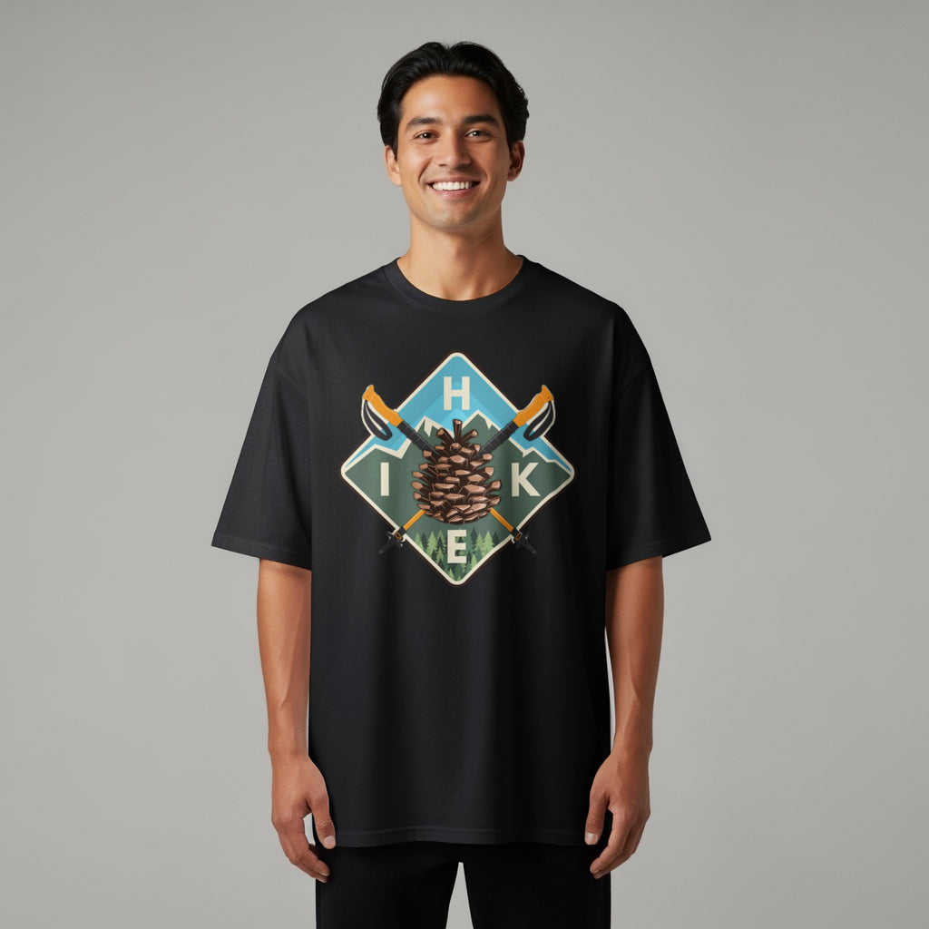 Black t-shirt with a diamond graphic featuring a pine cone, mountains, and hiking poles.
