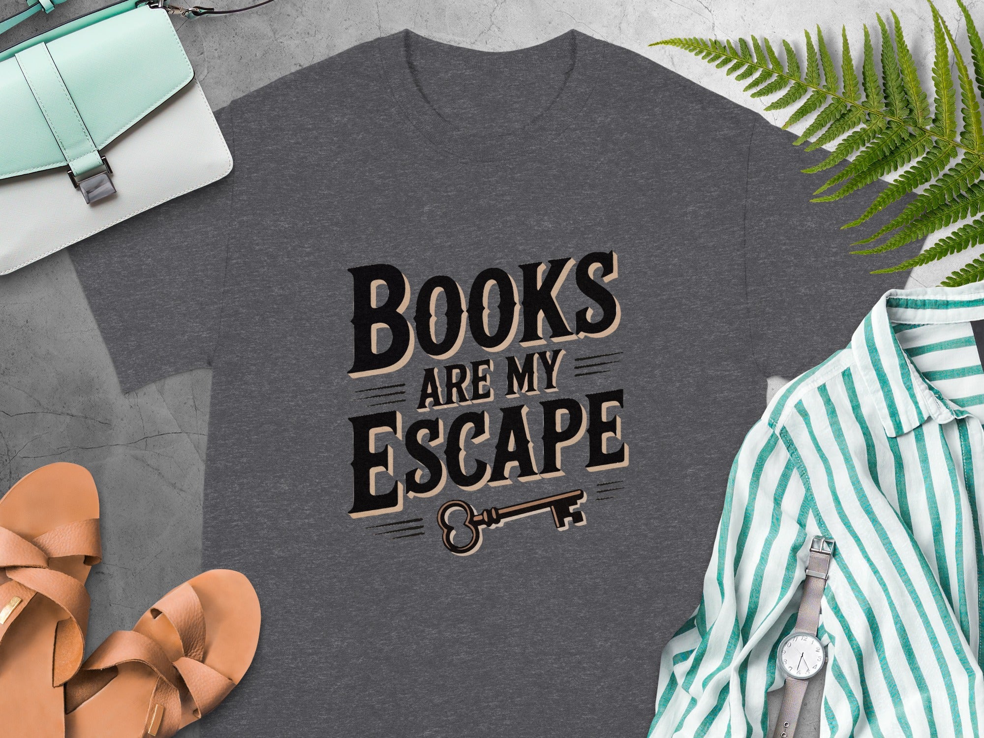 Dark grey t-shirt with "Books Are My Escape" text and a key graphic.