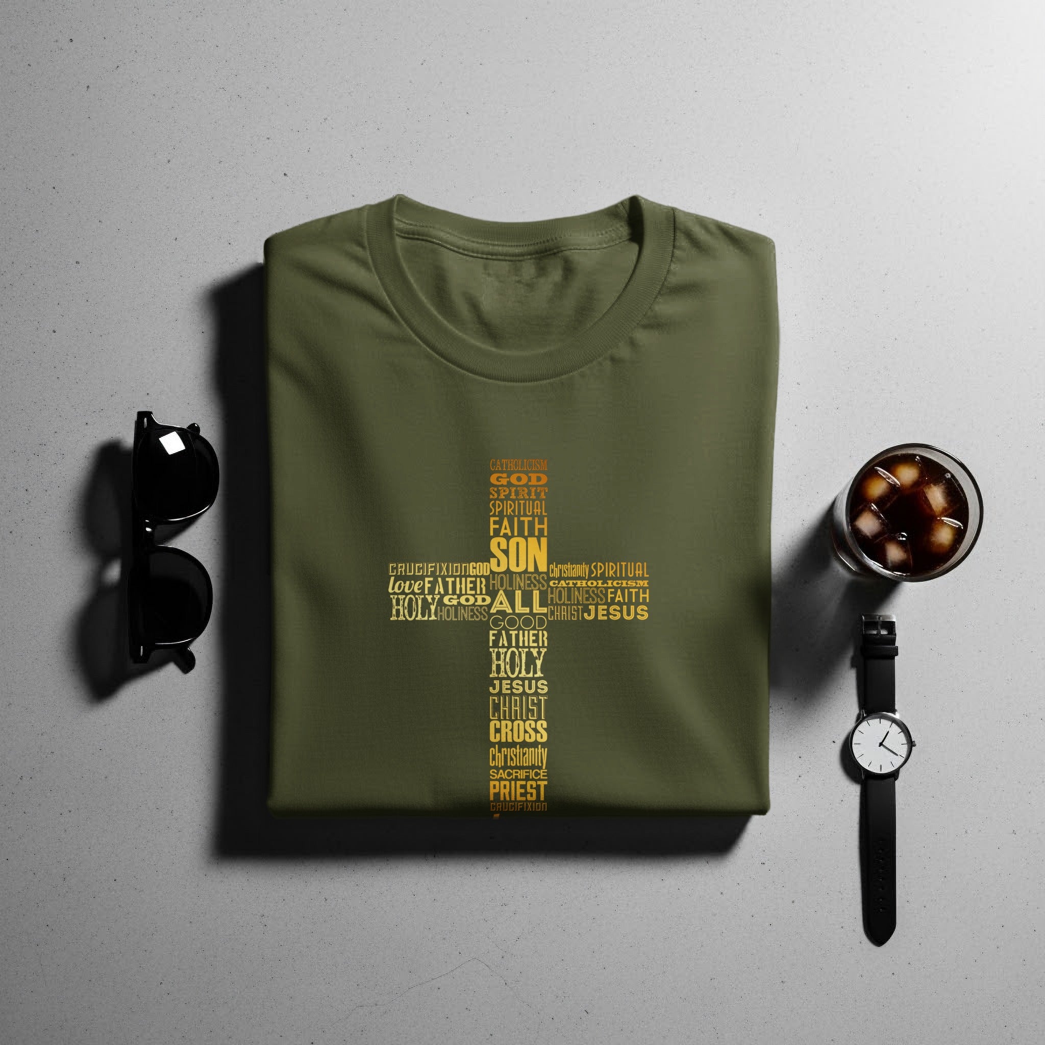 Olive green t-shirt with gold religious word art forming a cross.