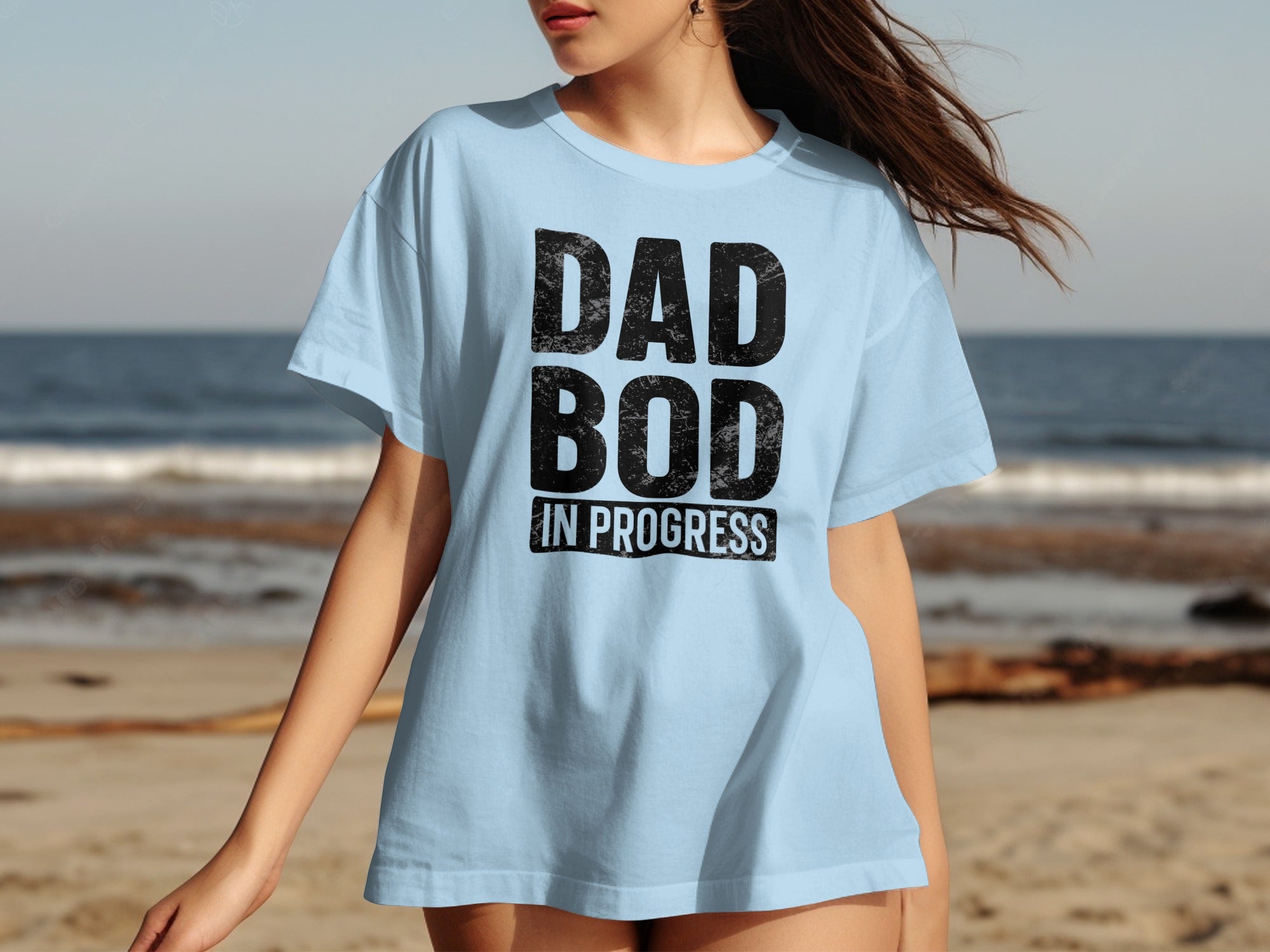 Light blue t-shirt with black distressed text "DAD BOD IN PROGRESS".