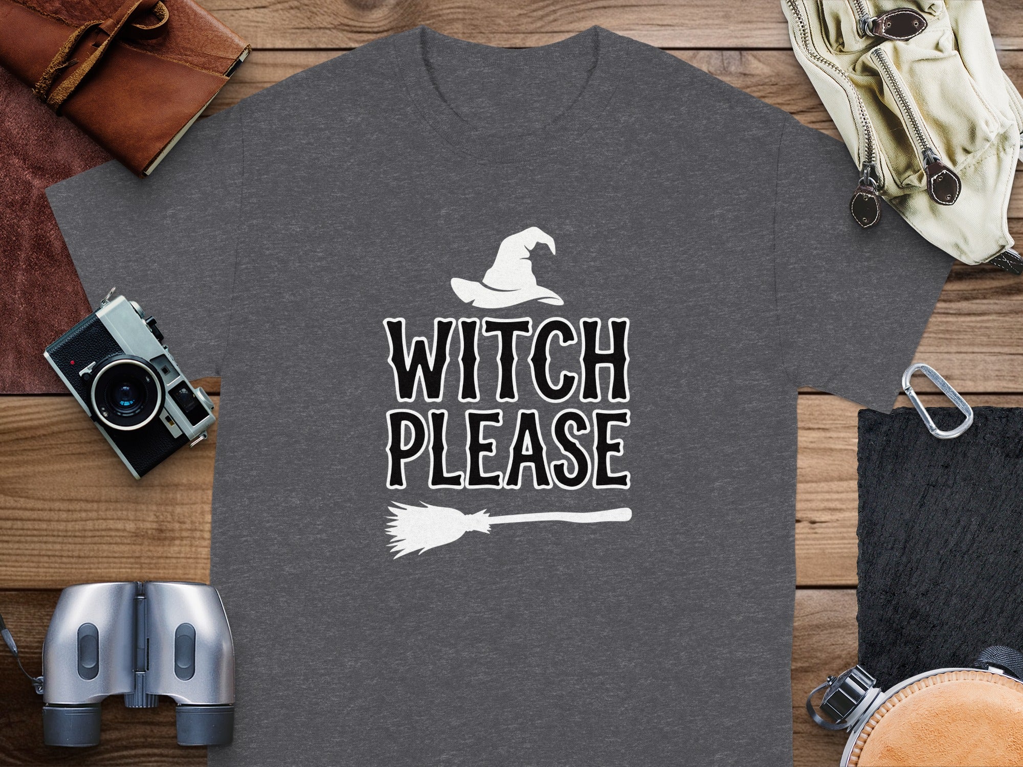 T-shirt with text "WITCH PLEASE" and graphics of a witch hat and broom