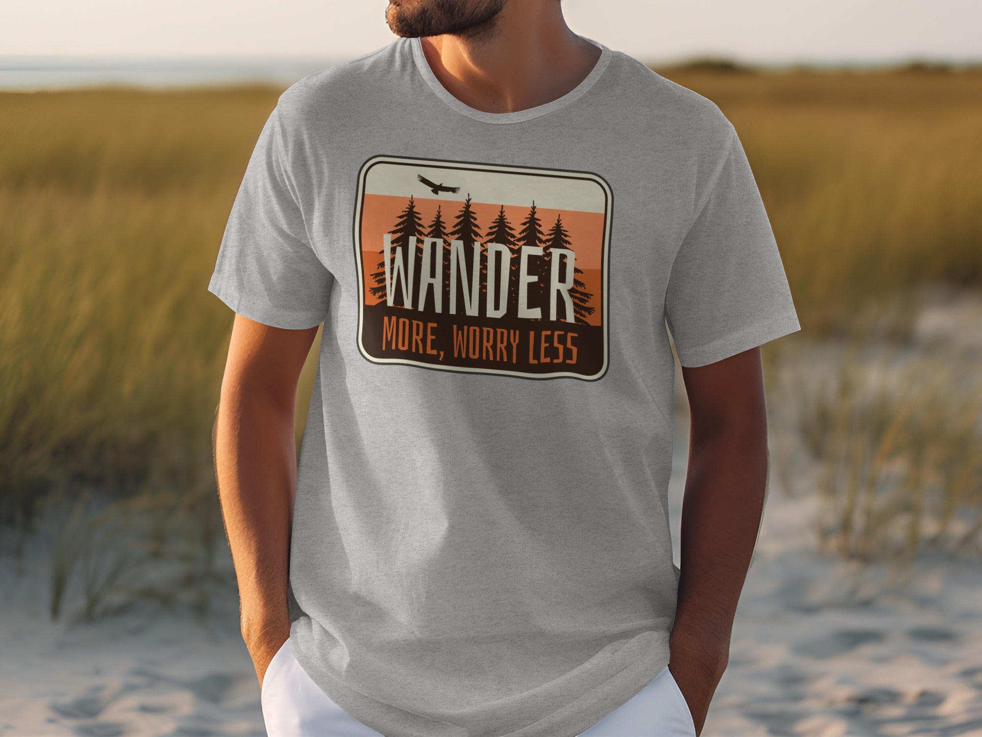 Grey t-shirt with "WANDER MORE, WORRY LESS" text and pine trees graphic.
