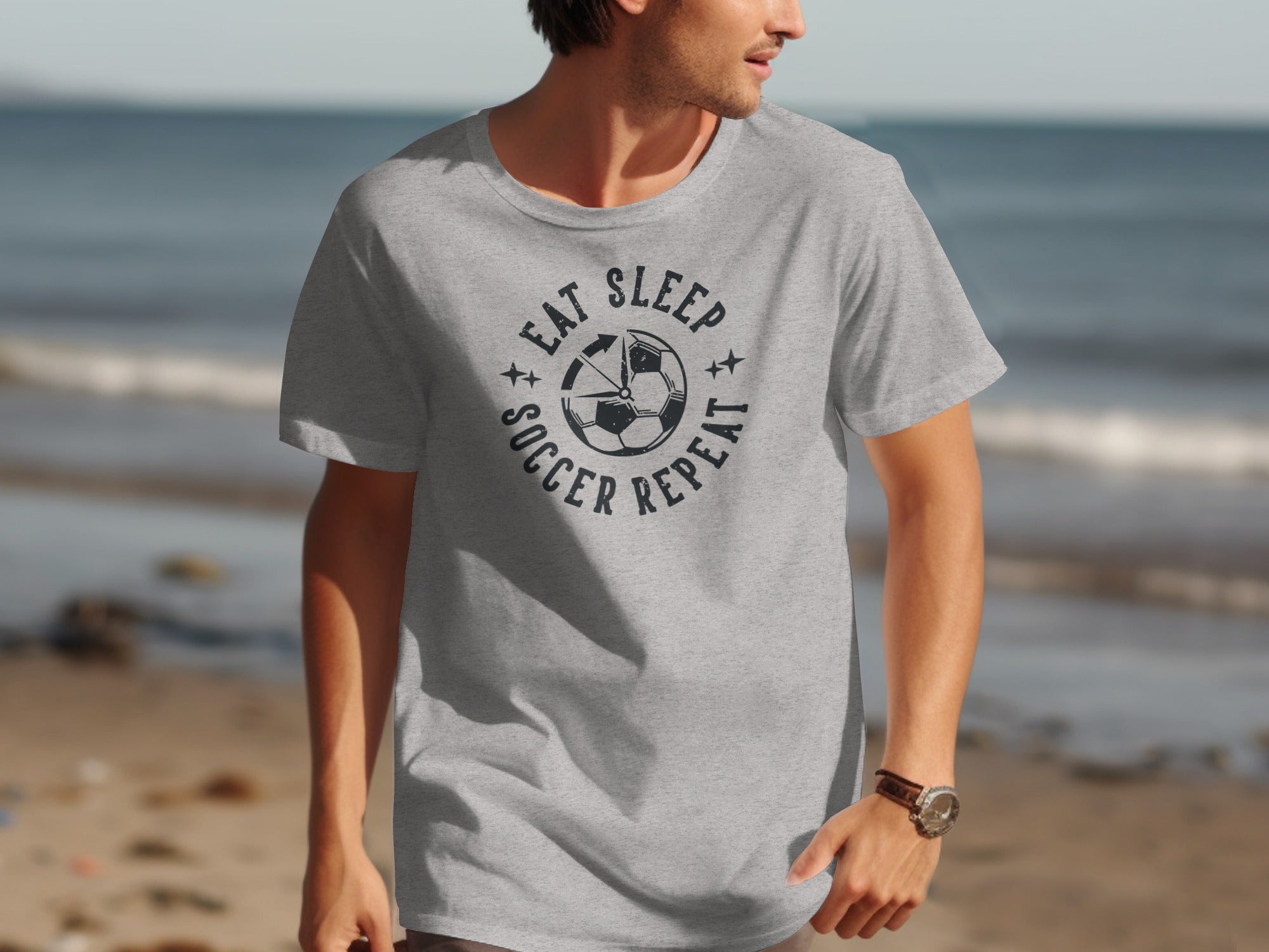 Grey t-shirt with "Eat Sleep Soccer Repeat" and soccer ball graphic.