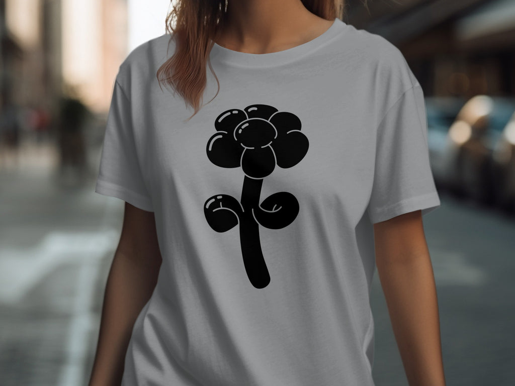 Black balloon flower graphic on a light gray t-shirt worn by a person.