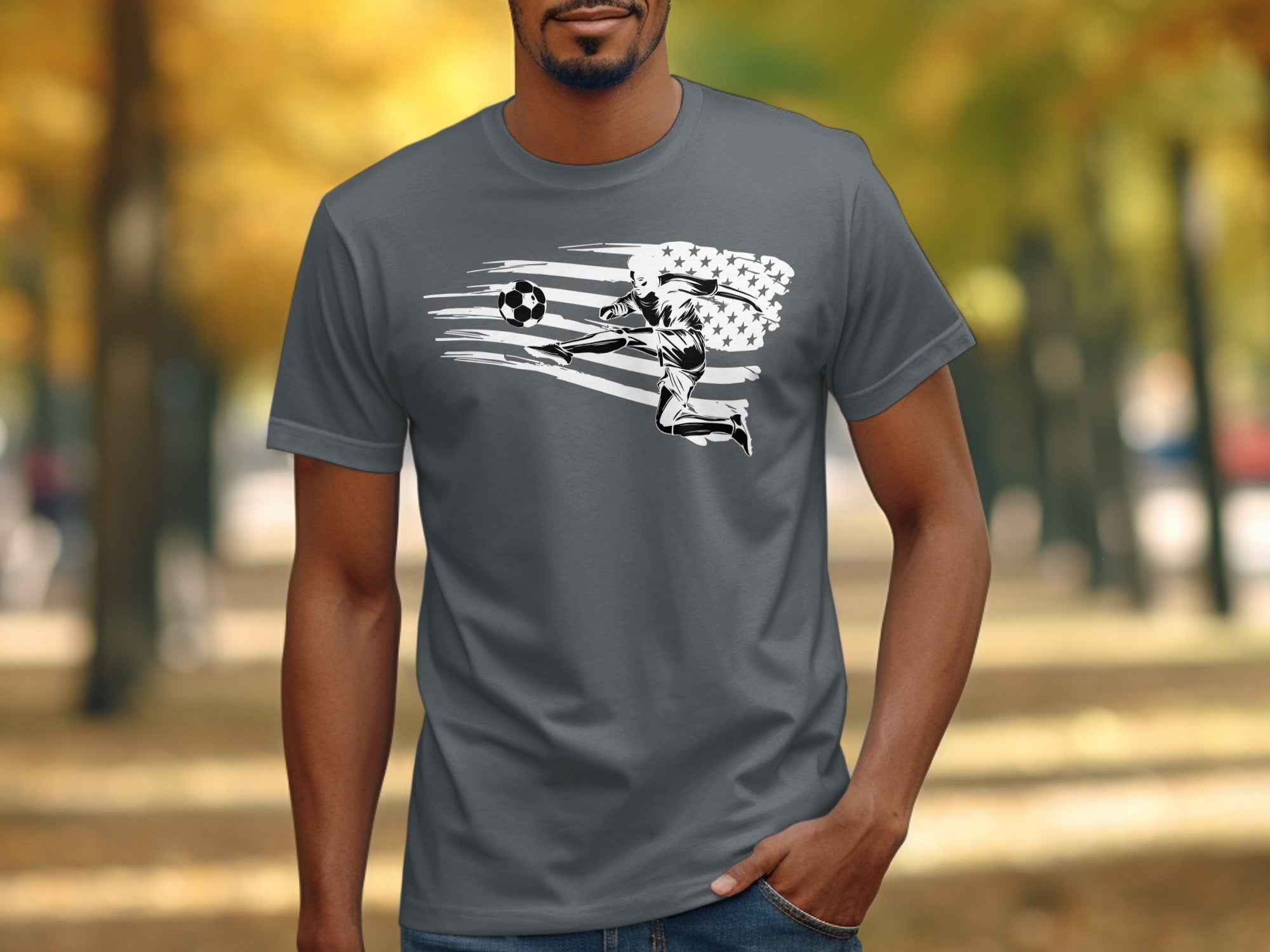 Soccer player kicking ball against American flag graphic on a gray t-shirt.