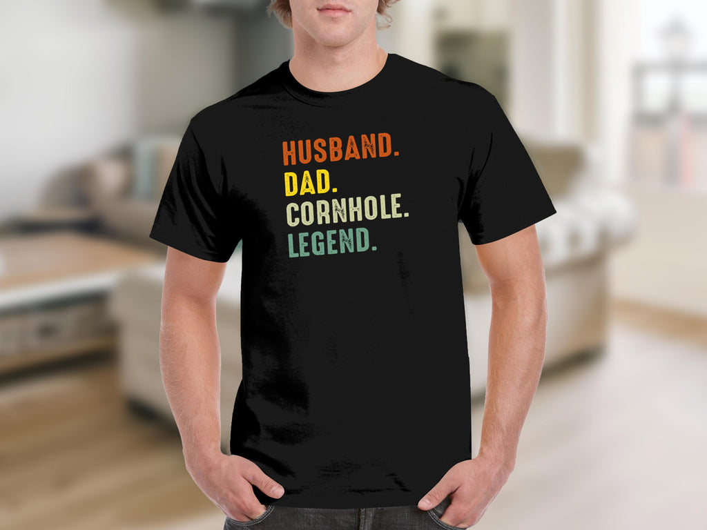 Black t-shirt with text "Husband. Dad. Cornhole. Legend."