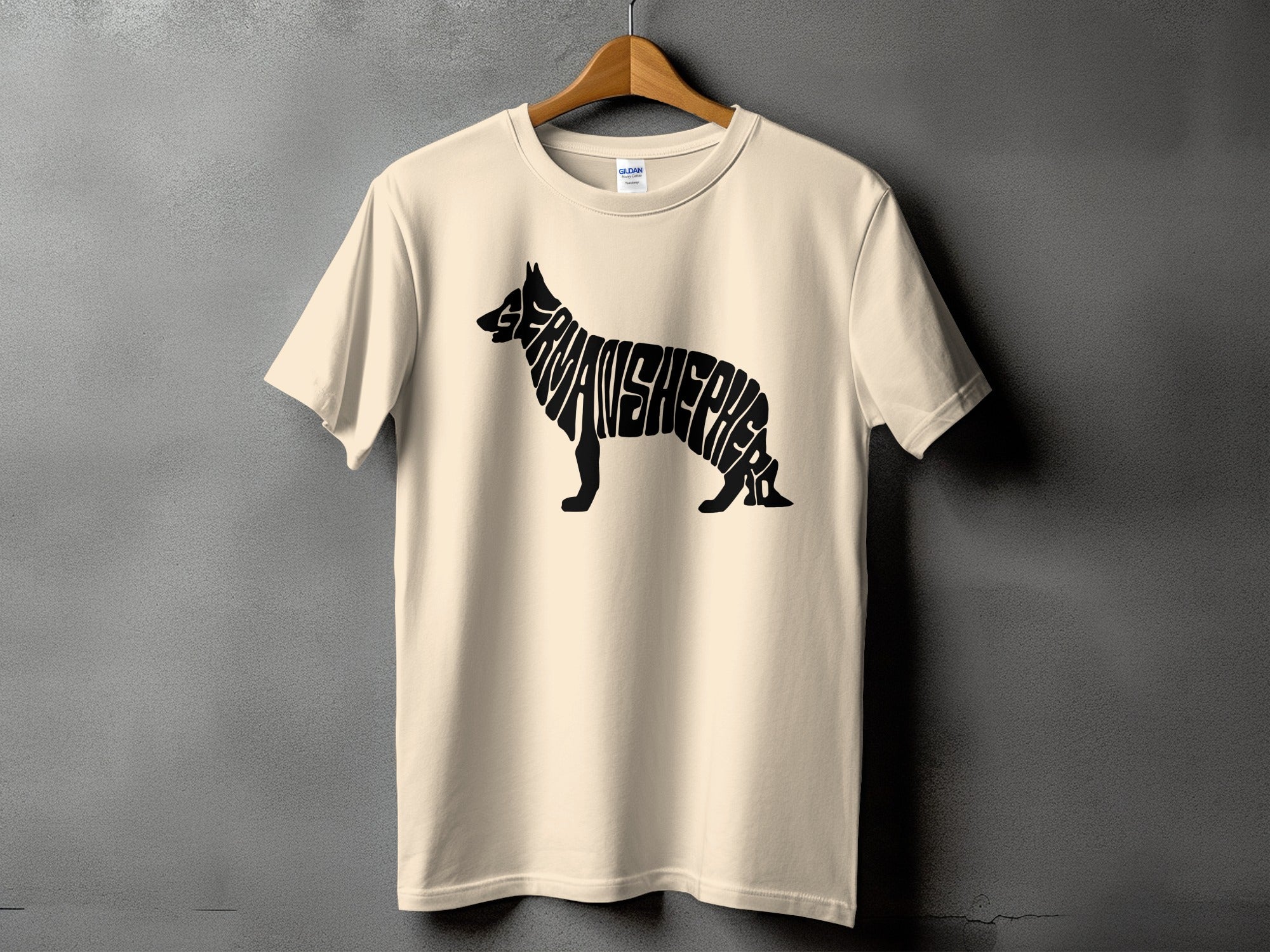 Cream t-shirt with "GERMAN SHEPHERD" text forming the silhouette of a German Shepherd dog.