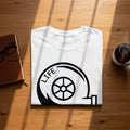 White t-shirt with black graphic of a wheel and the word "LIFE".