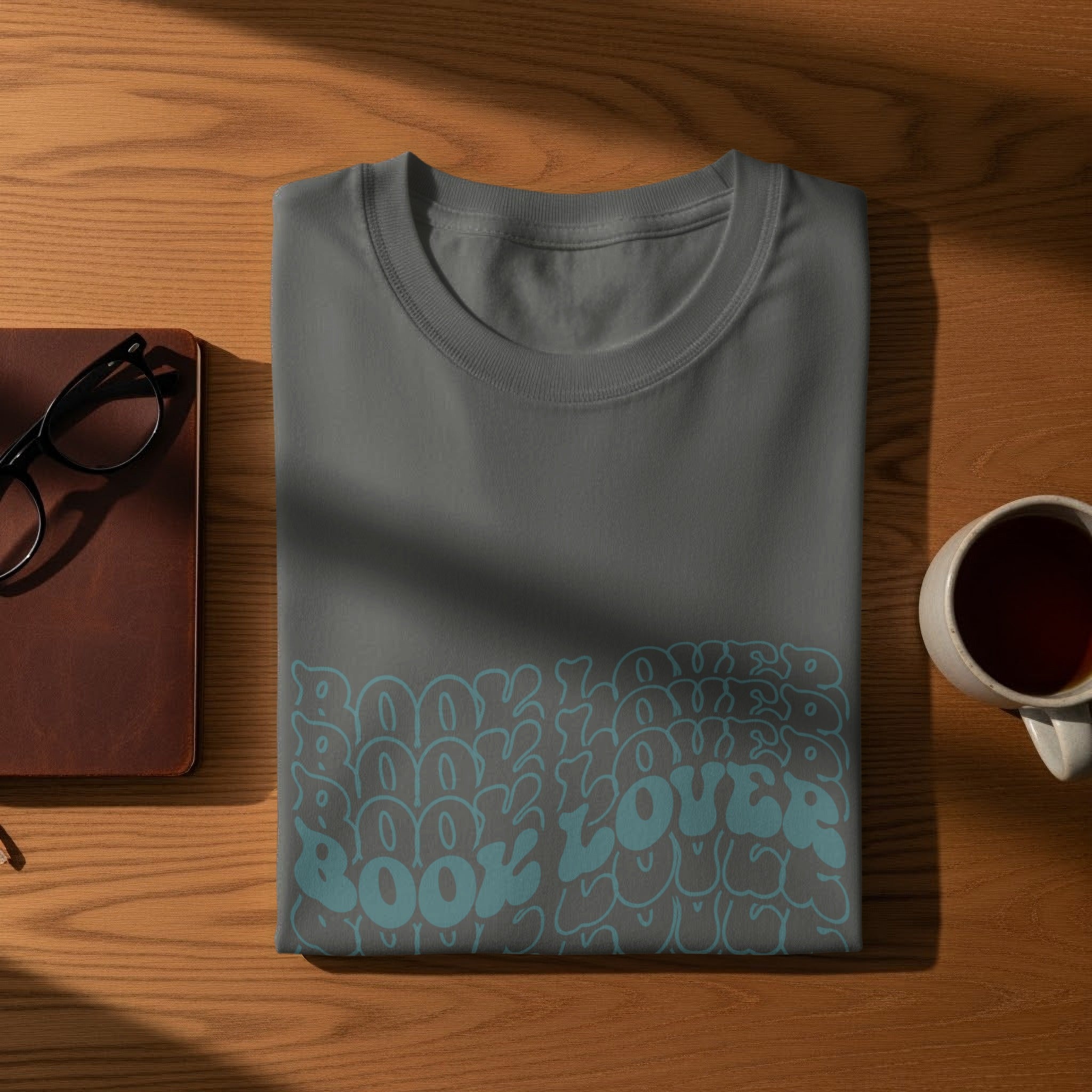 Grey t-shirt with "Book Lover" in bubble letters and a cup of tea.