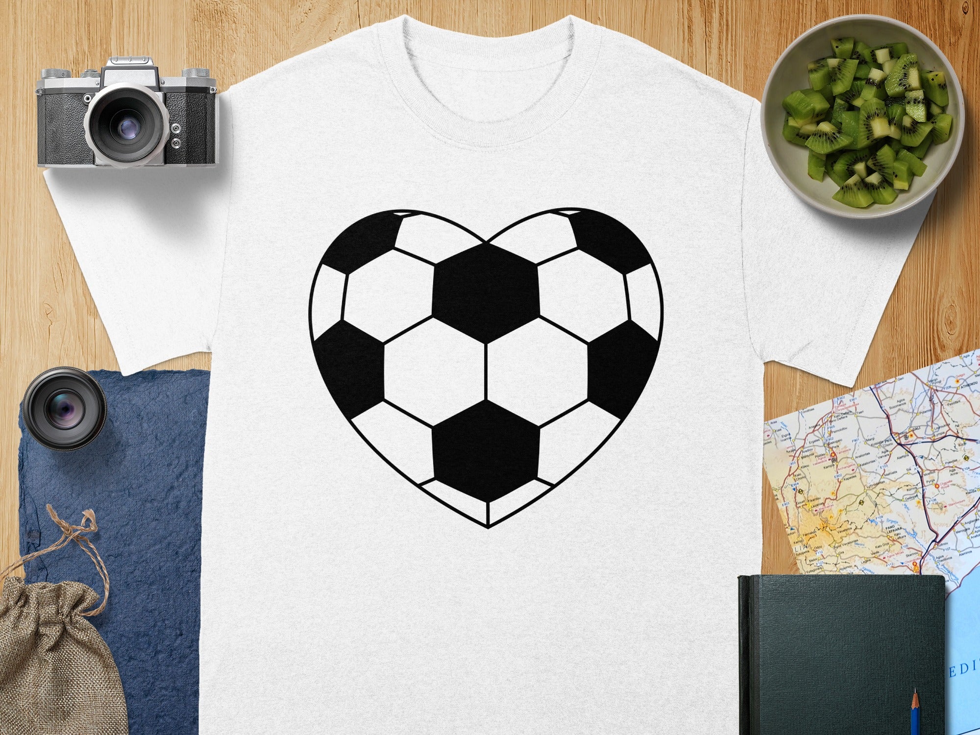 White t-shirt with a black heart-shaped soccer ball graphic.