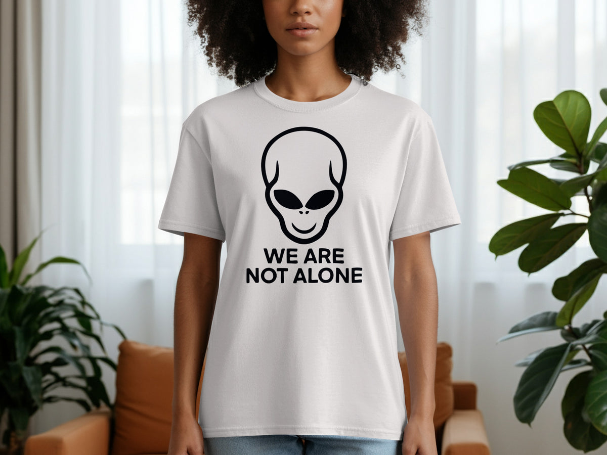 White t-shirt with alien graphic and text "We Are Not Alone"