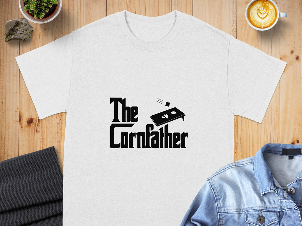 White t-shirt with "The Cornfather" text and cornhole board graphic.