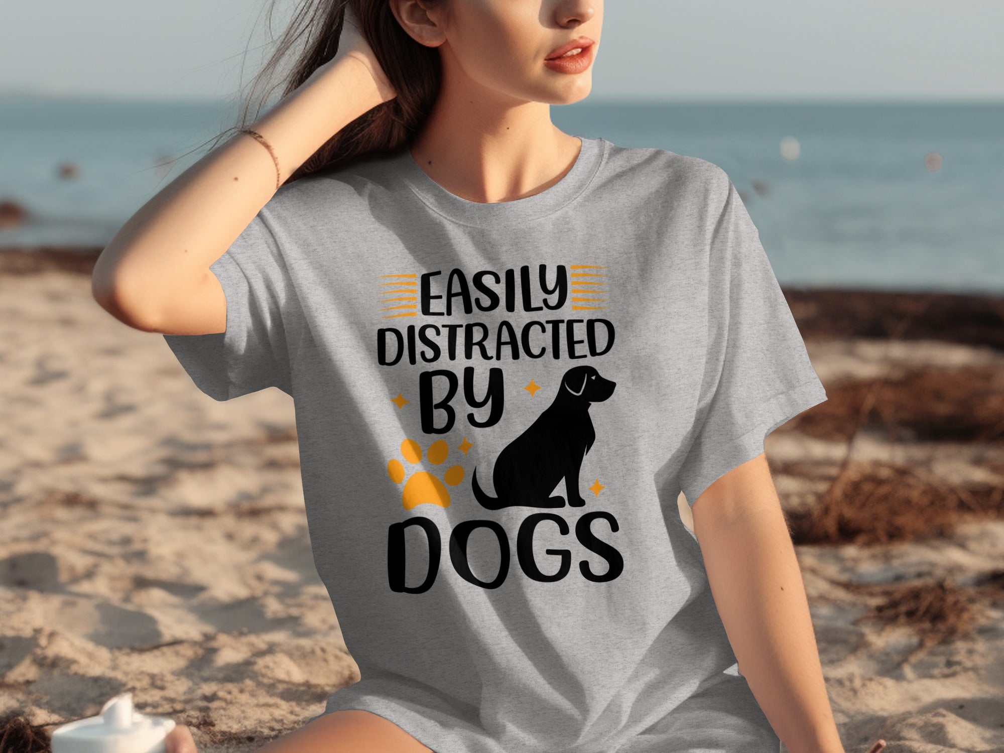 Grey t-shirt with text "Easily Distracted By Dogs," a dog silhouette, and paw print.