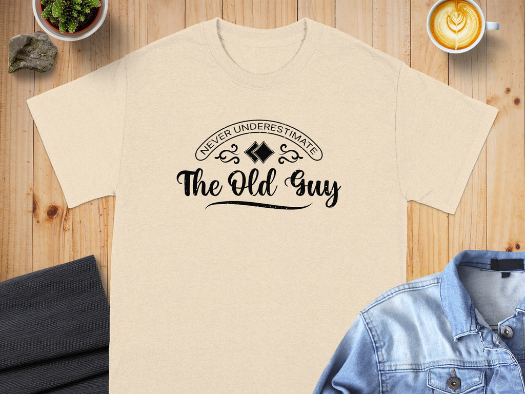Light beige t-shirt with "Never Underestimate The Old Guy" text graphic.