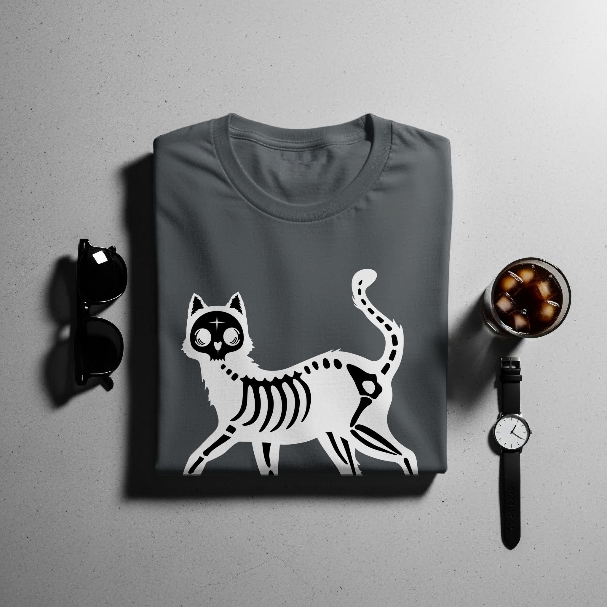Dark grey t-shirt with a white skeleton cat graphic, sunglasses, and a drink.