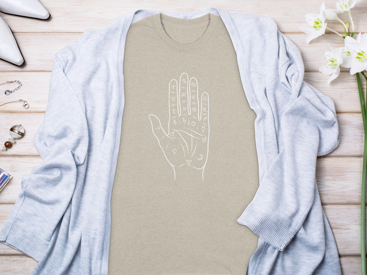 Tan t-shirt with white outline of palmistry hand with astrological symbols.