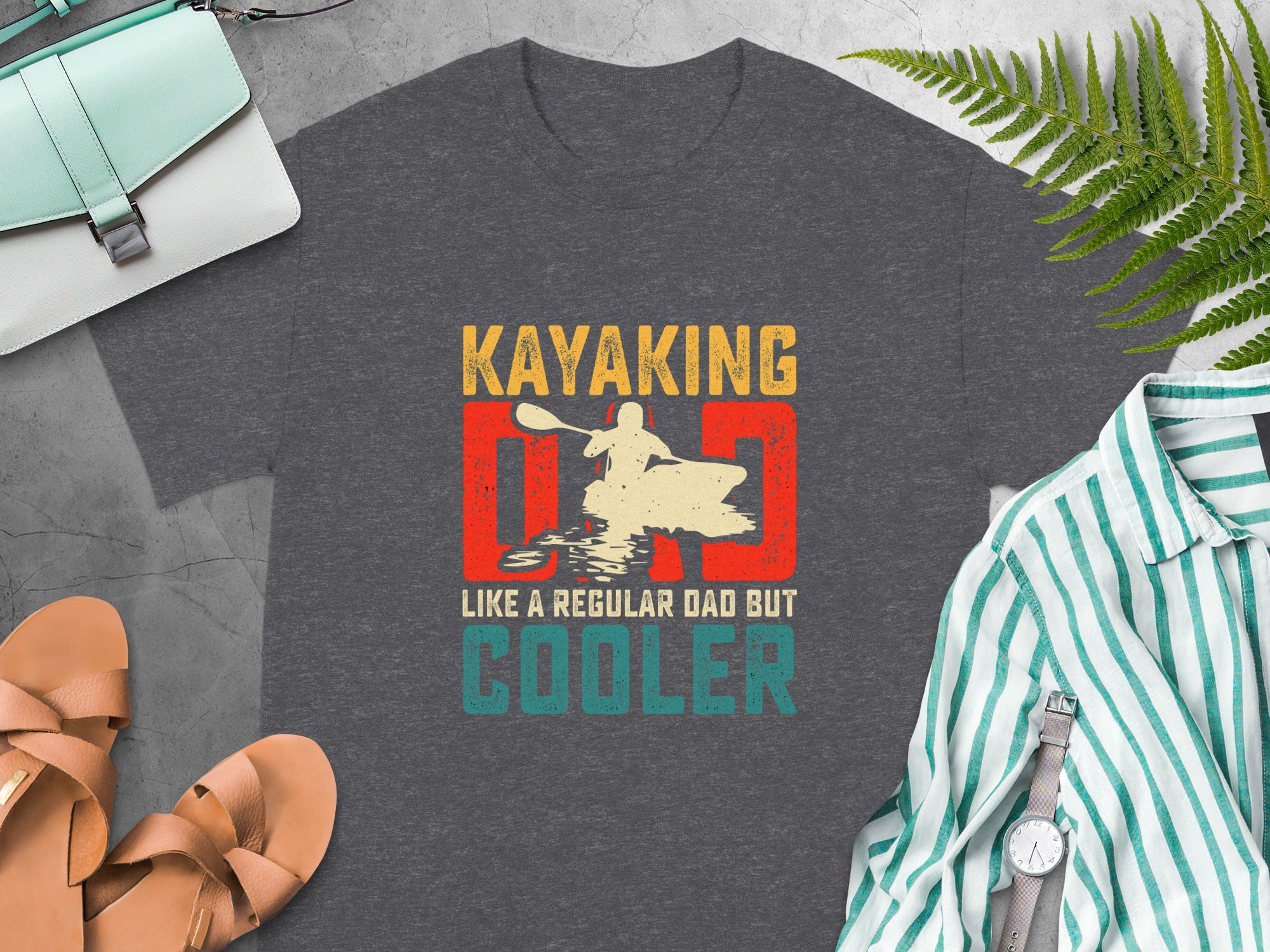 Dark grey t-shirt with "Kayaking Dad Like a Regular Dad But Cooler" graphic.