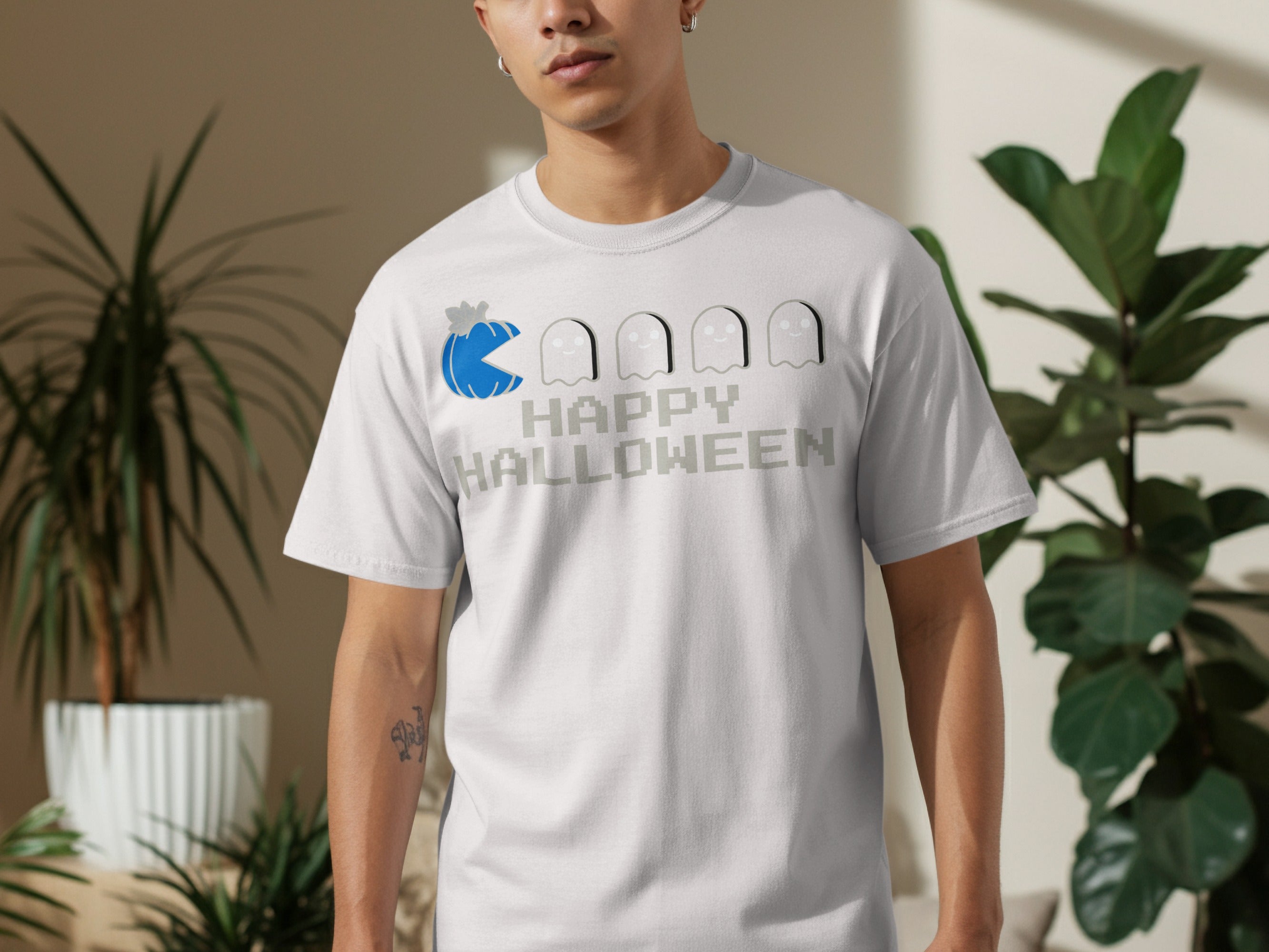 White t-shirt with a Pac-Man pumpkin and ghosts graphic, saying "Happy Halloween."