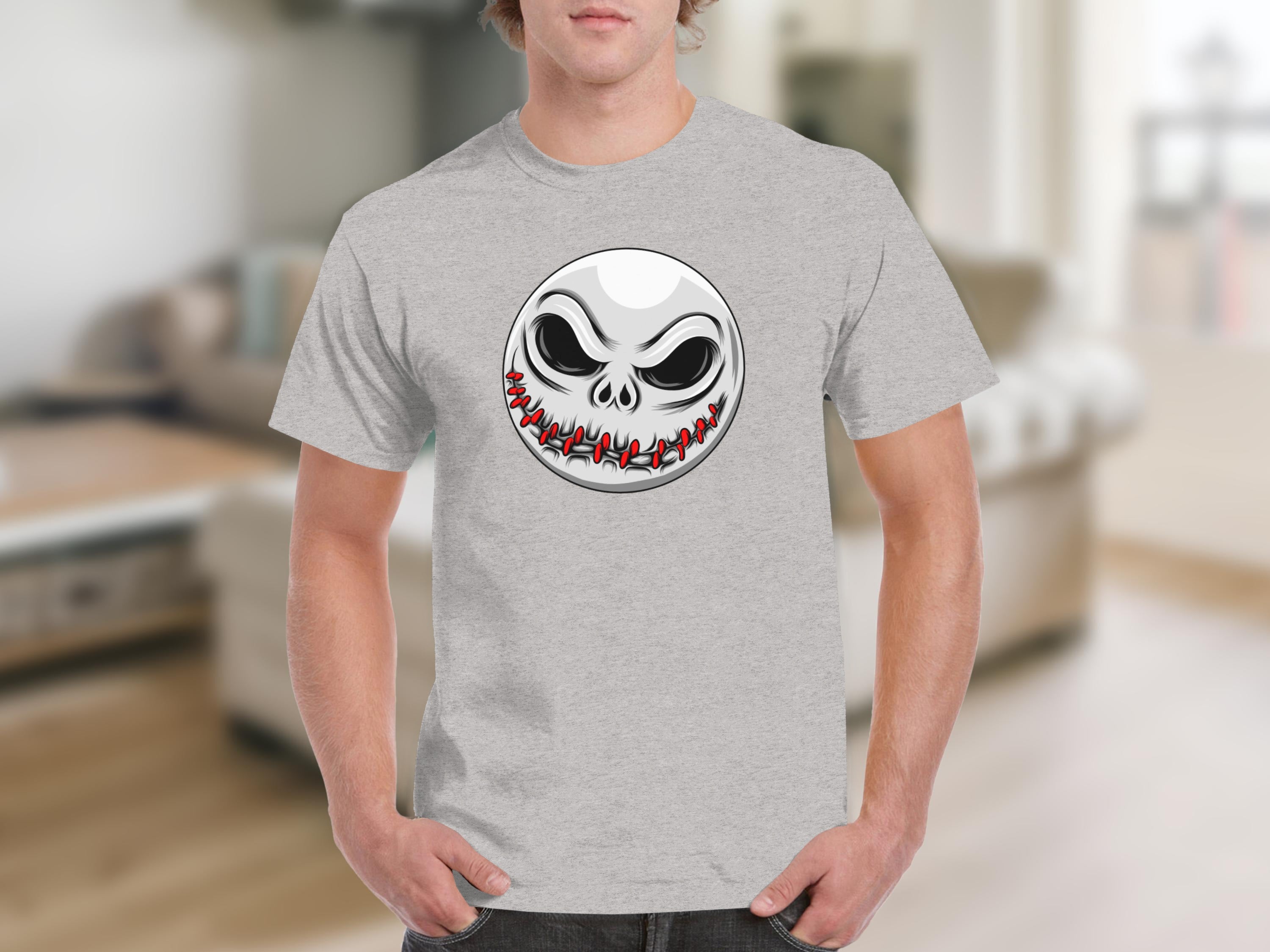 Grey t-shirt with a cartoon skull face featuring stitched mouth and dark eyes.