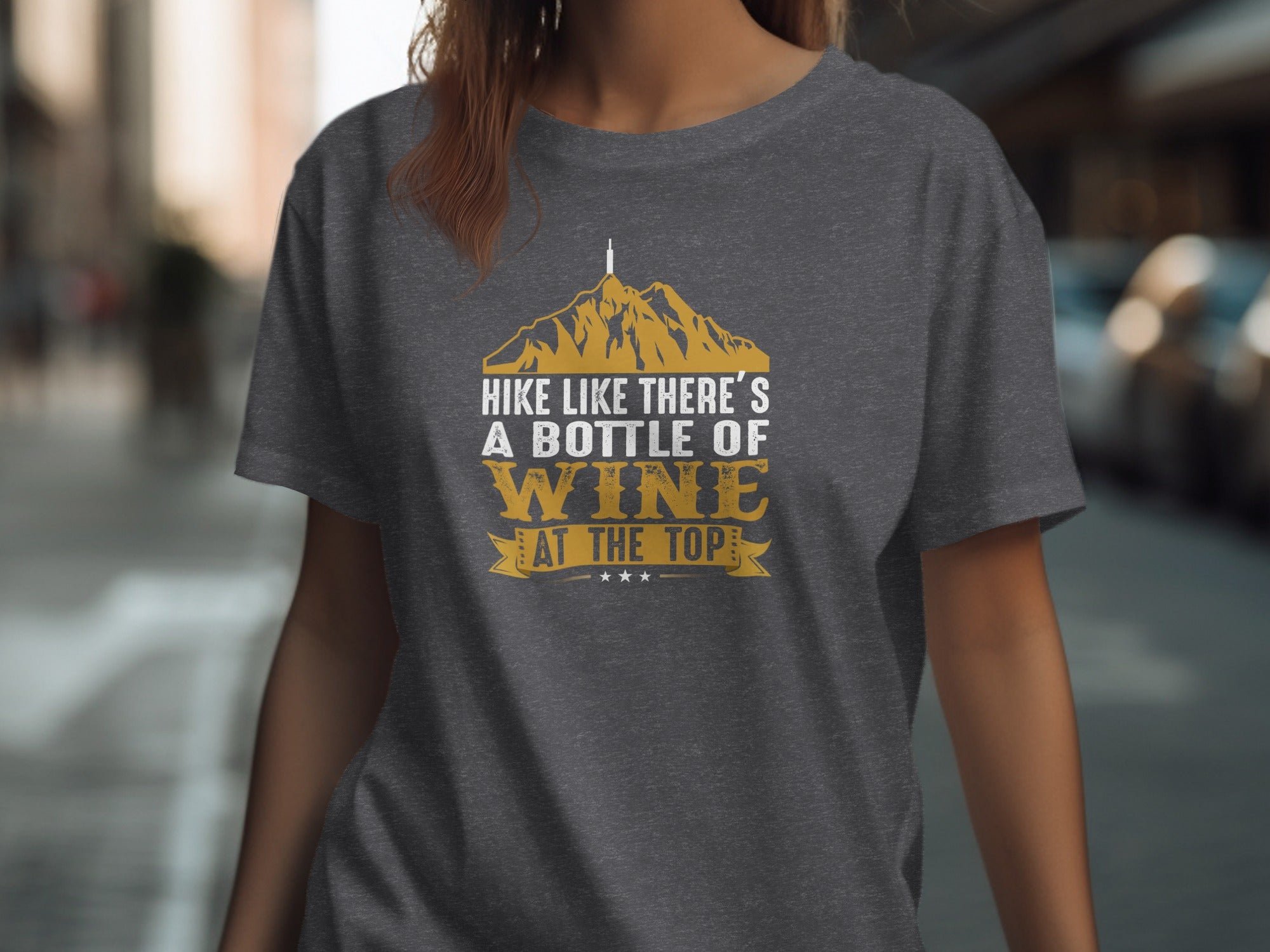 Dark gray t-shirt with text "HIKE LIKE THERE'S A BOTTLE OF WINE AT THE TOP".