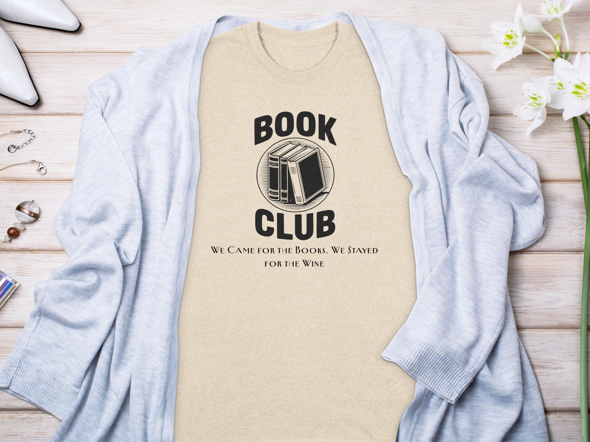 Light beige t-shirt with "Book Club" and wine quote, layered with a light blue cardigan.