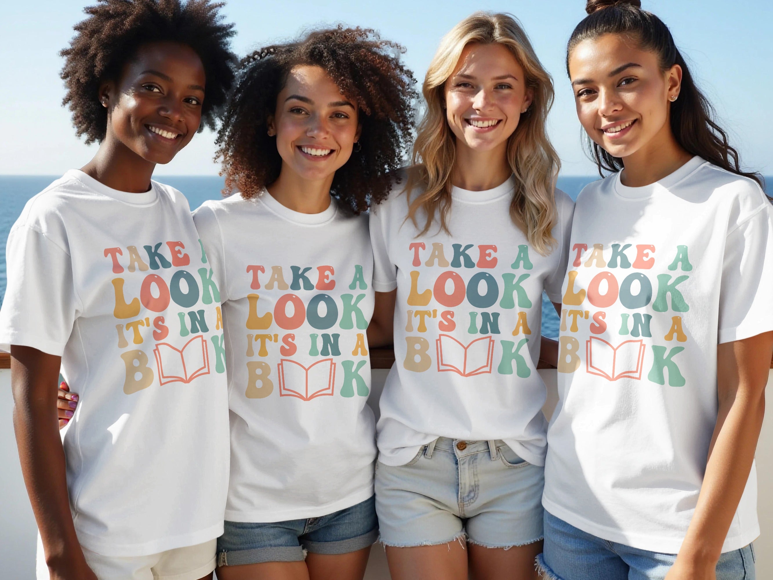 Four young women wear white t-shirts with "Take a look, it's in a book" graphic.