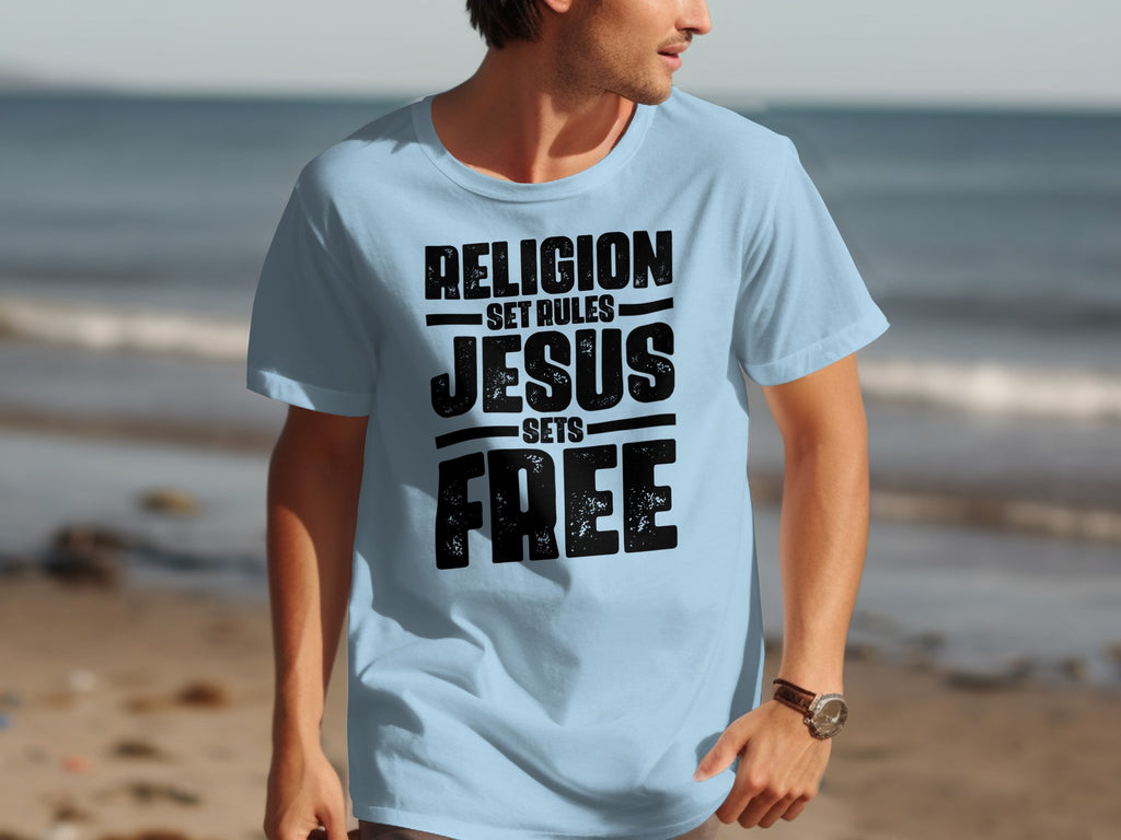 Light blue t-shirt with black distressed text: "Religion Set Rules, Jesus Sets Free."