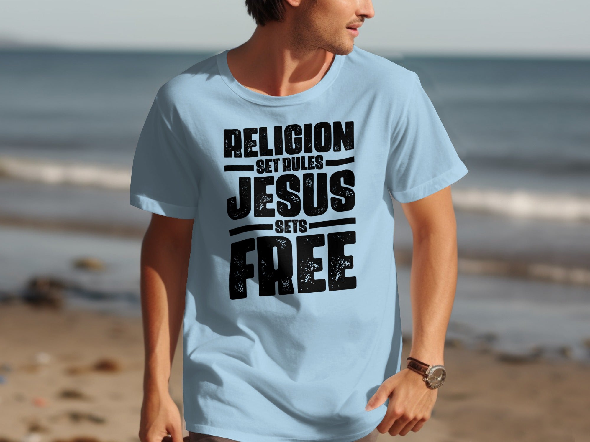 Light blue t-shirt with black distressed text: "Religion Set Rules, Jesus Sets Free."