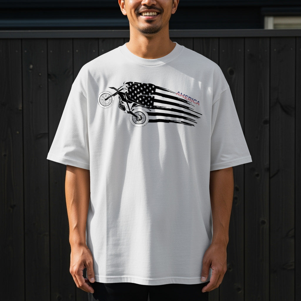White t-shirt with a dirt bike graphic overlaid with an American flag and the word "AMERICA".