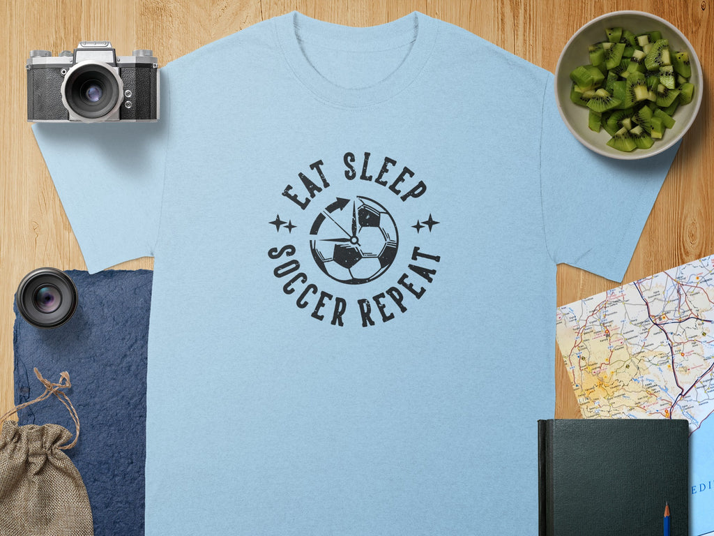 Light blue t-shirt with "Eat Sleep Soccer Repeat" text and a soccer ball graphic.
