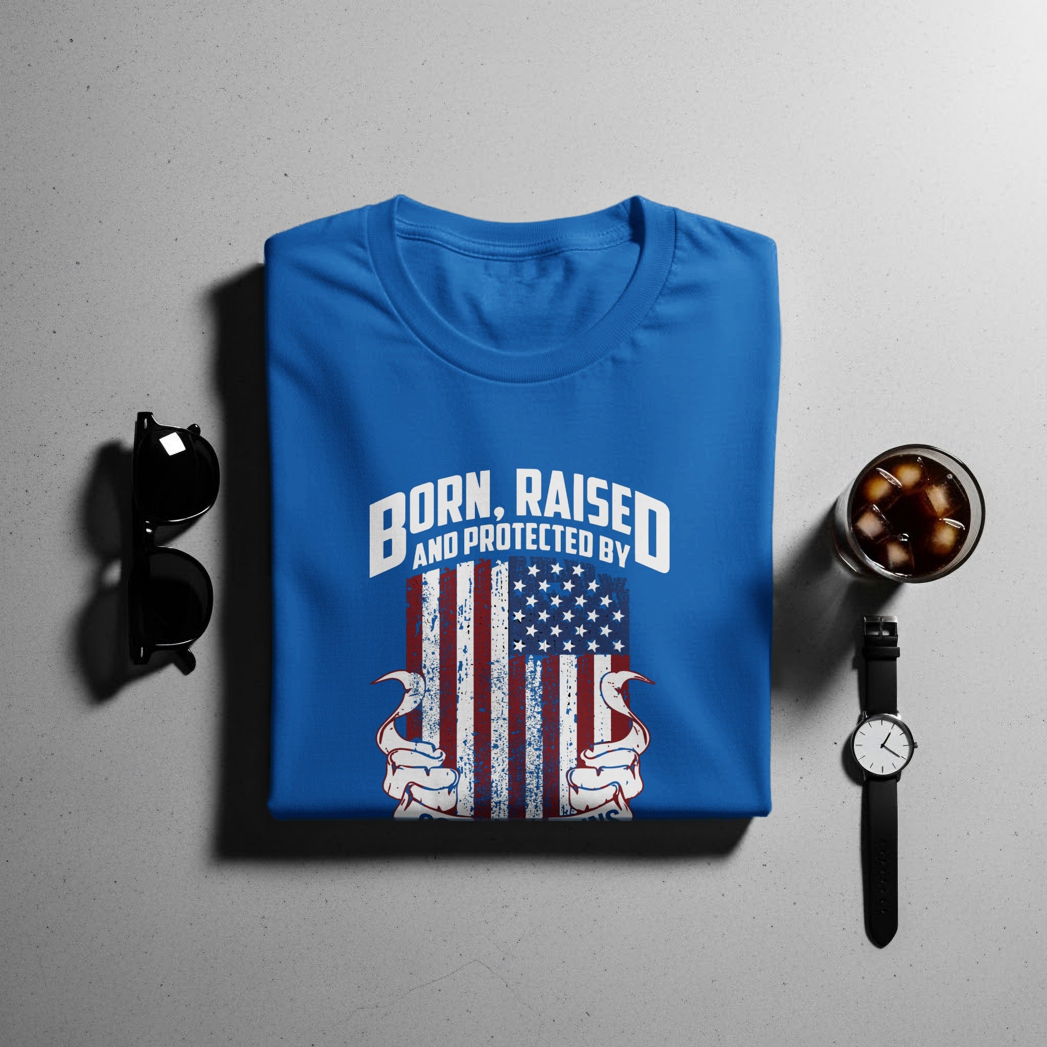 Blue t-shirt with distressed American flag and "Born, Raised, and Protected By" text.
