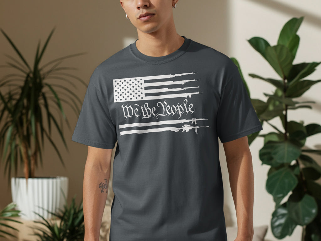 Dark grey t-shirt with white graphic of US flag and guns, "We the People".