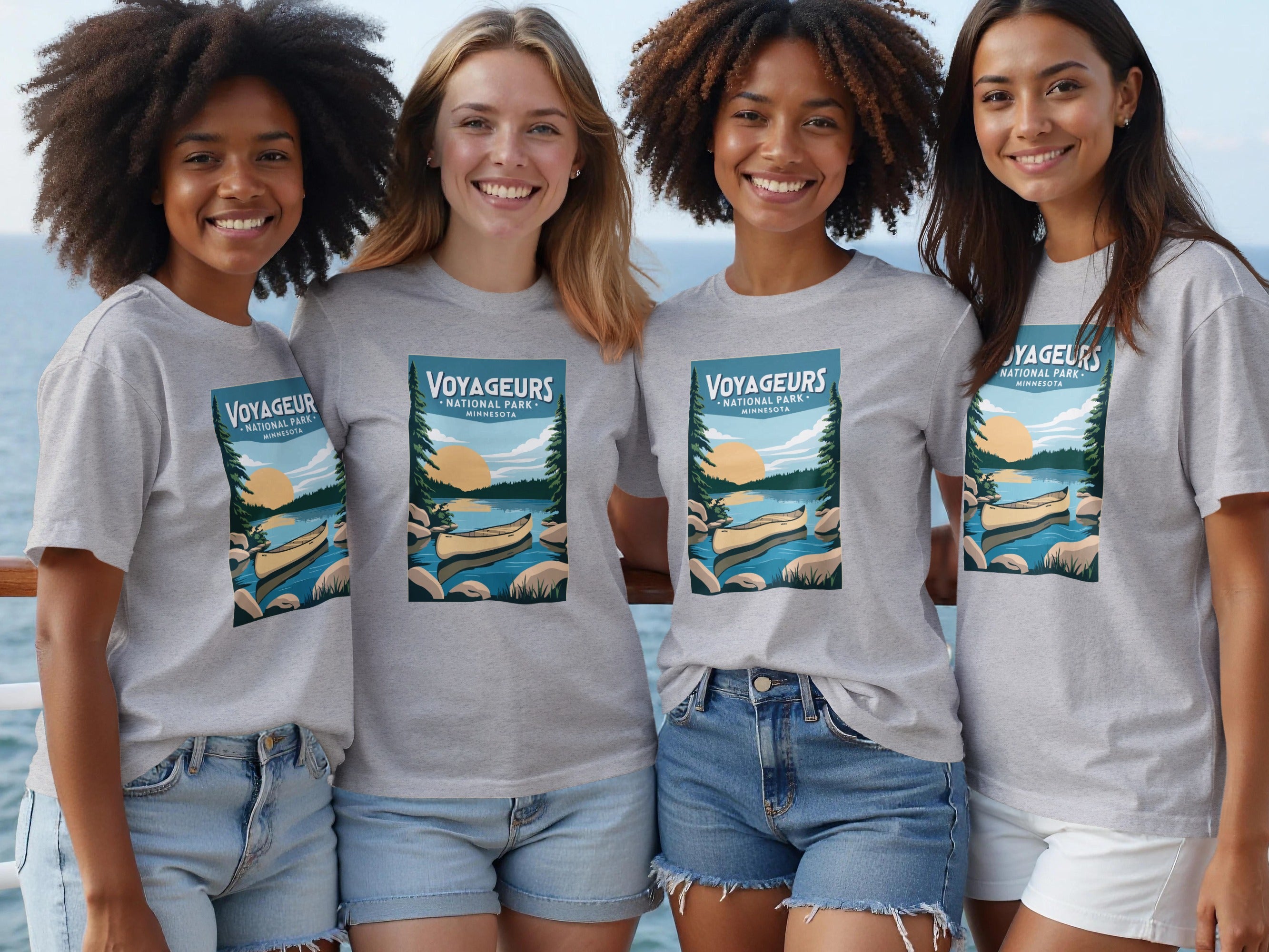 Four women wear gray t-shirts with Voyageurs National Park Minnesota designs.