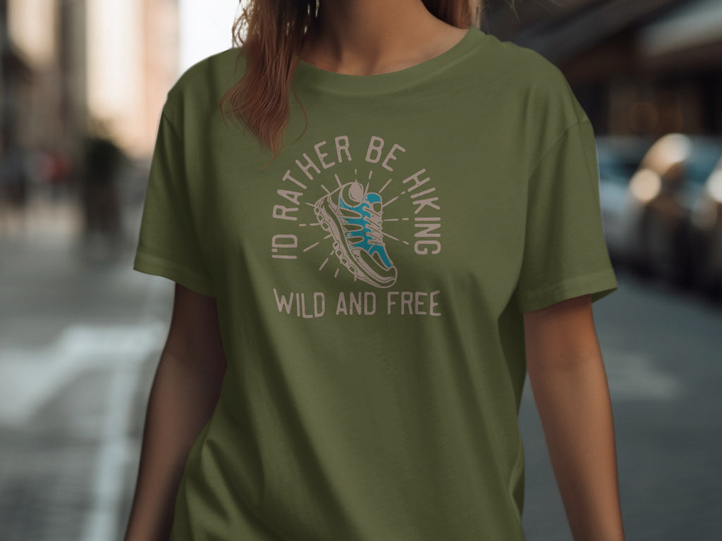 Olive green t-shirt with "I'd rather be hiking wild and free" text and shoe graphic.
