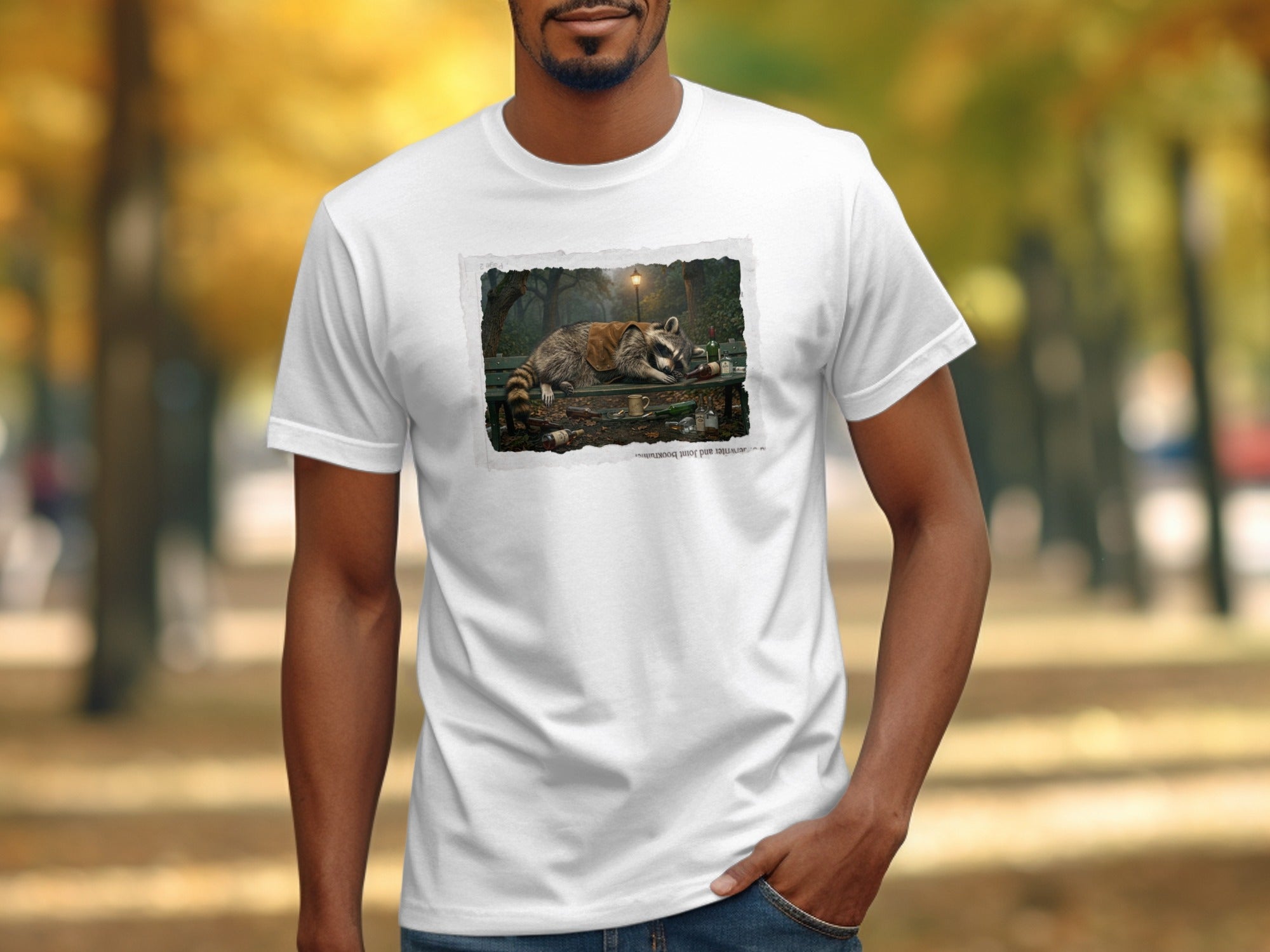 T-shirt with a graphic of a raccoon lying on a park bench full of bottles.