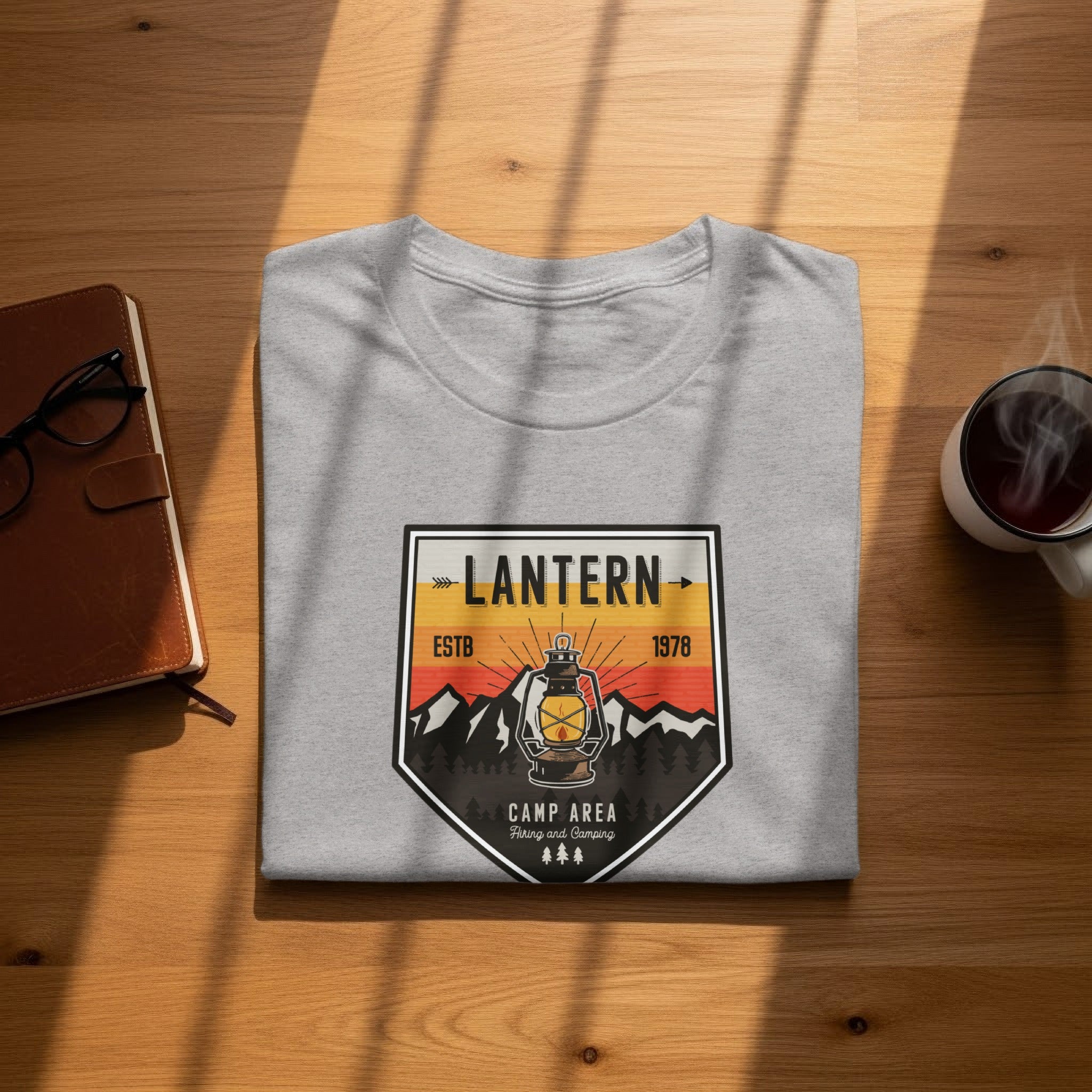 Light gray t-shirt with a vintage lantern, mountains, and text.