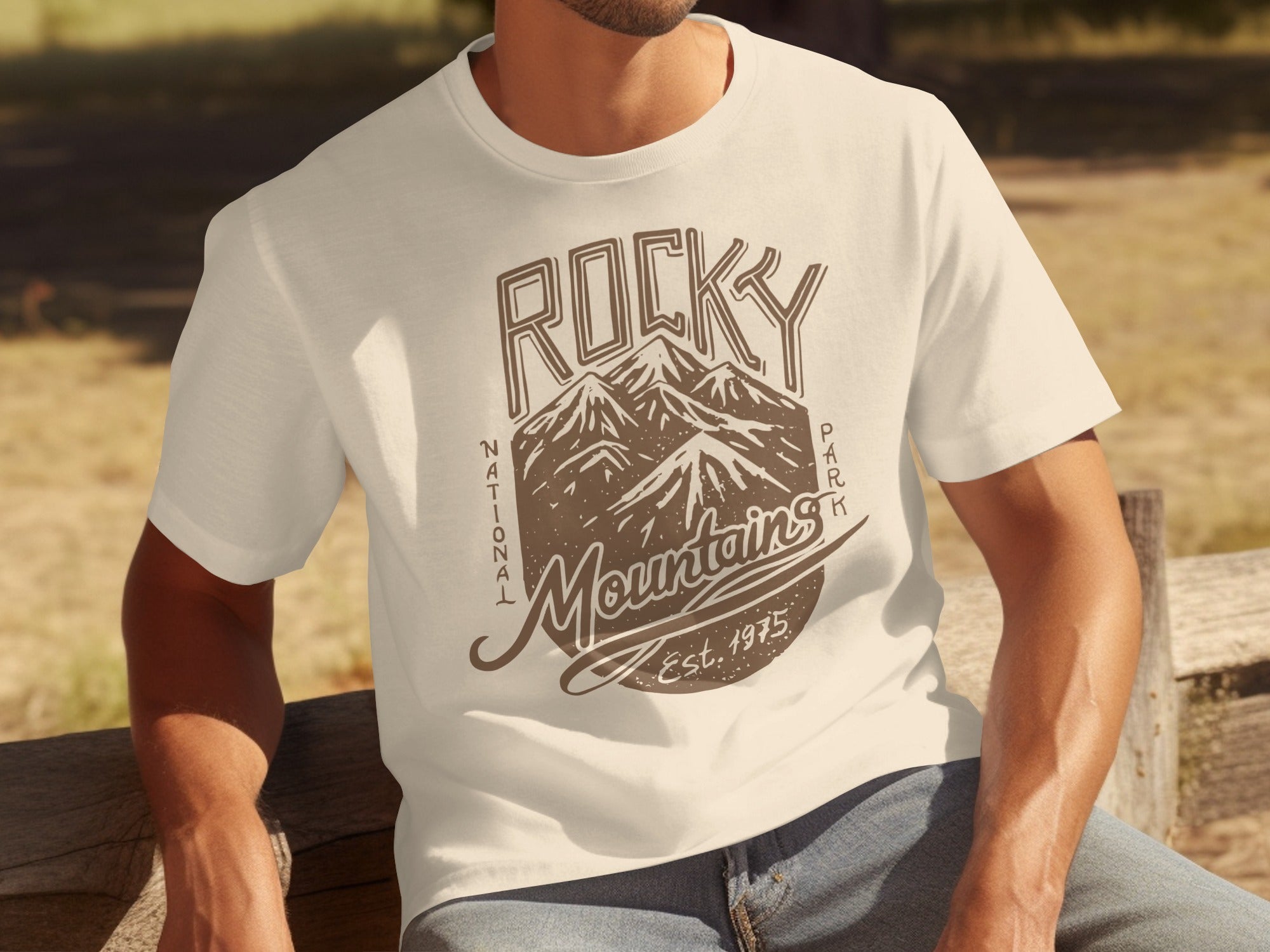 Cream t-shirt with "Rocky Mountains National Park Est. 1975" graphic design.