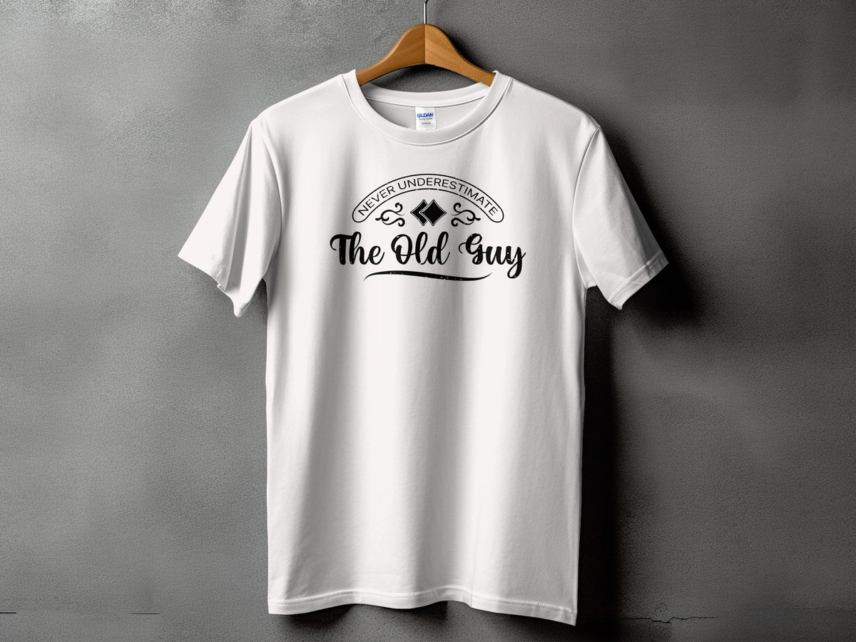 White t-shirt with black text "Never Underestimate The Old Guy".