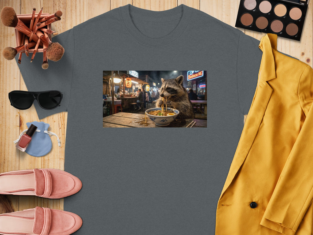 T-shirt with raccoon eating ramen at night market graphic.